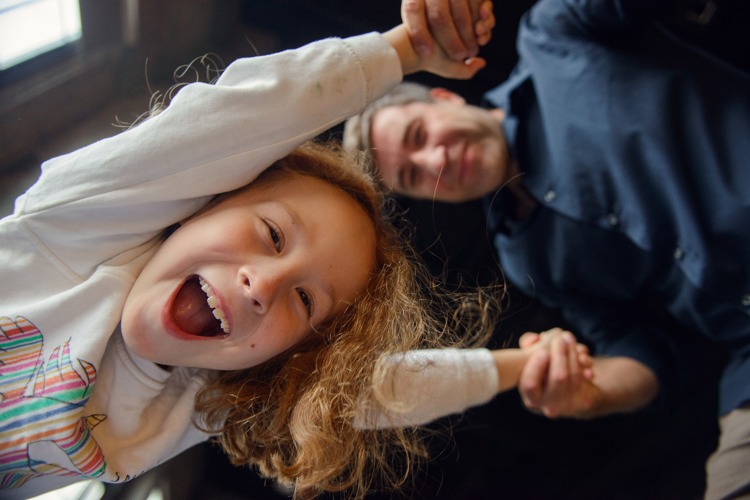 dad and daughter in a dark photo studio