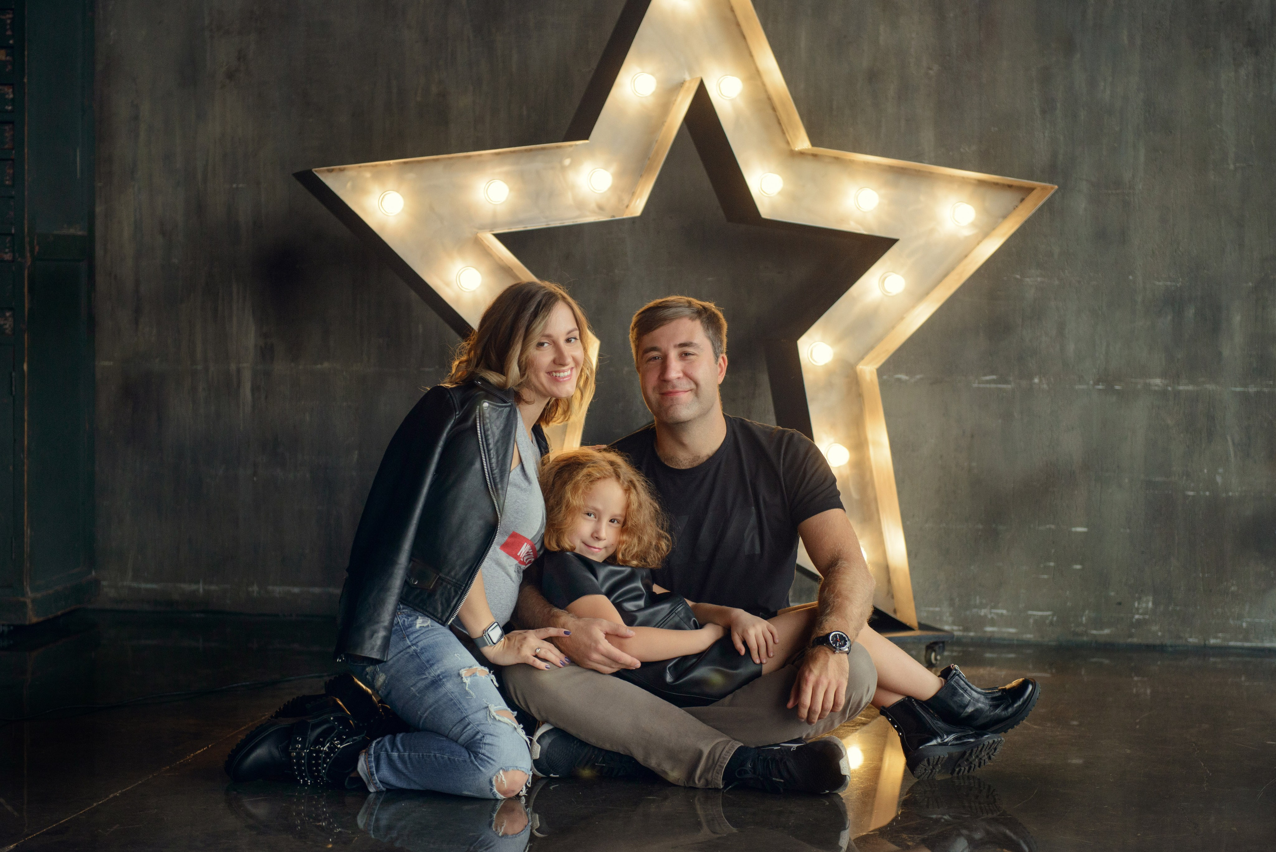 Family photo shoot with a pregnant woman in a loft studio, rock and roll style