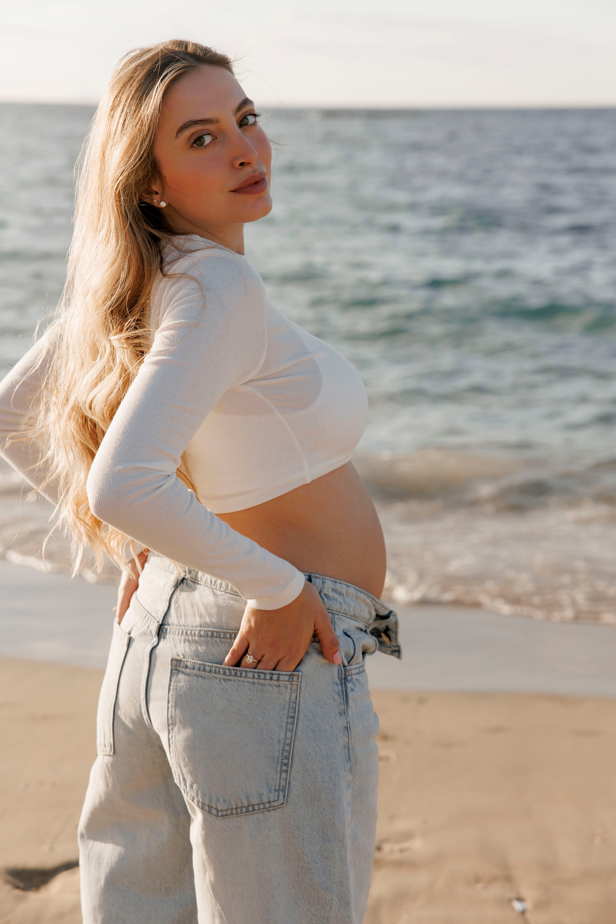 Pregnancy photoshoot near the sea. Wedding and family photographer
