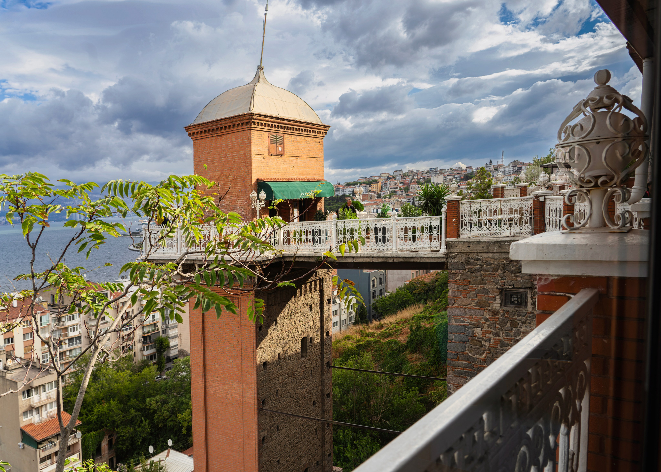 Historic Asansör elevator in Izmir, brick tower with a dome, view over the city and bay, architectural photography.