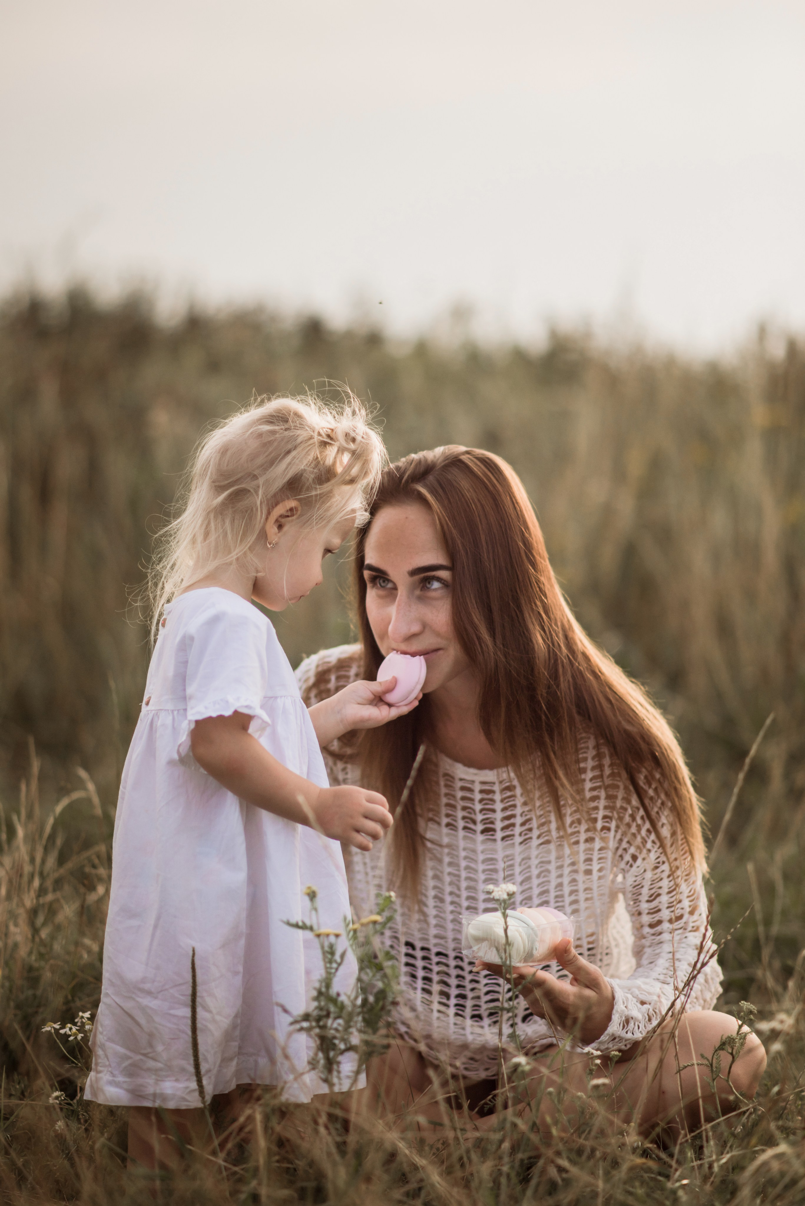 Mom sitting with her children in a meadow