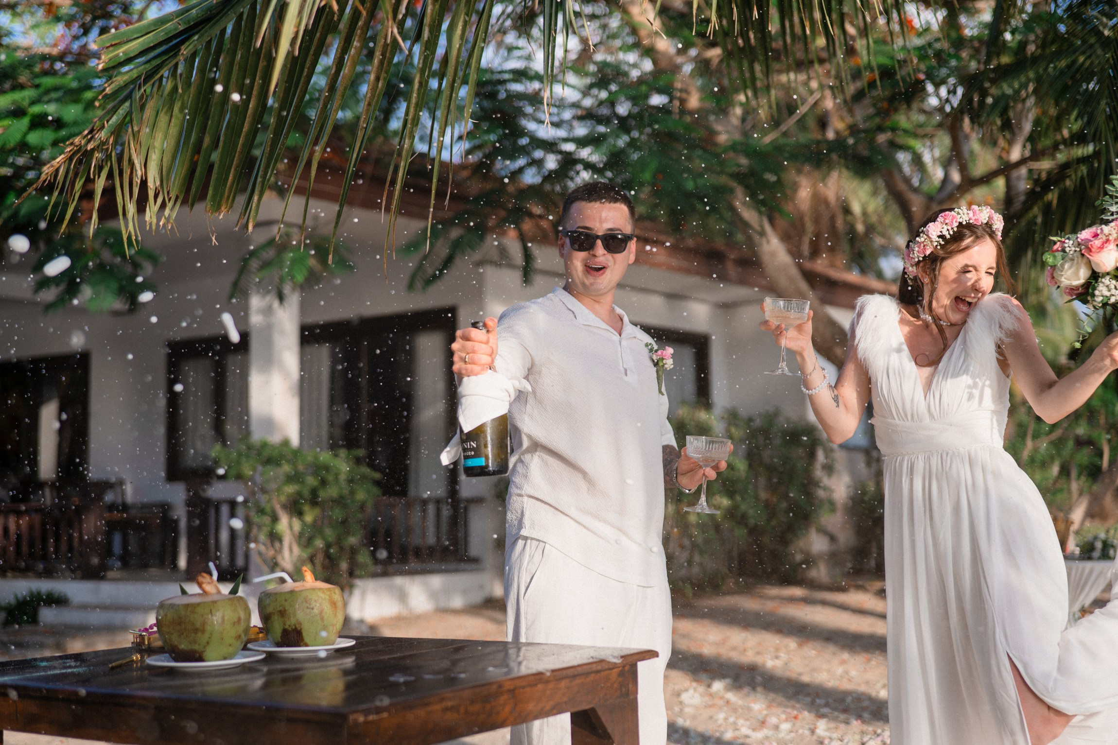 Bride and groom exchanging vows on a private sunset beach