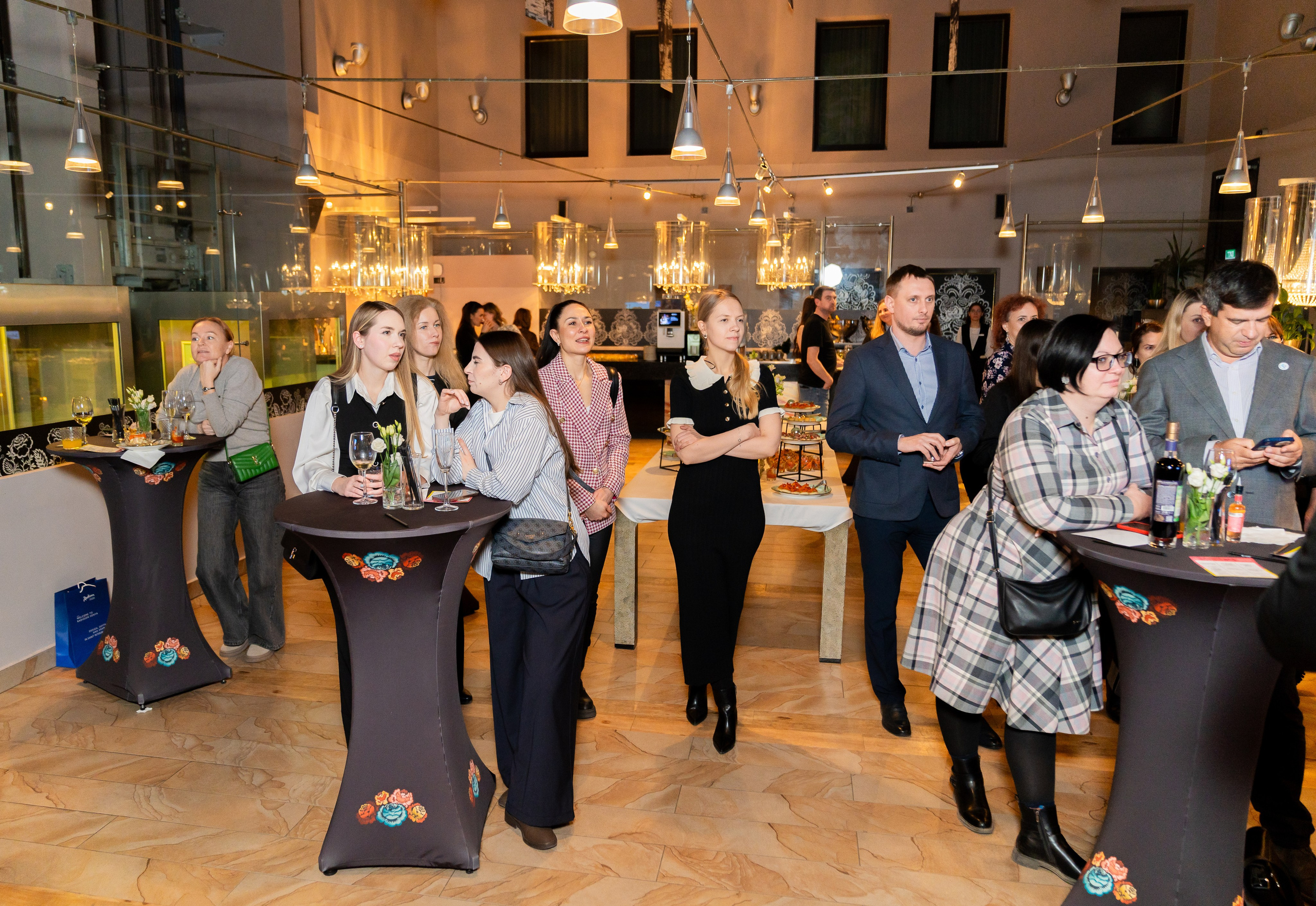 Гости вечеринки общаются за высокими фуршетными столами в зале Radisson Sonya. Корпоративное мероприятие с дегустацией. Фото Евгения Мальцева, альбом Radisson Sonya, evrednix.ru.