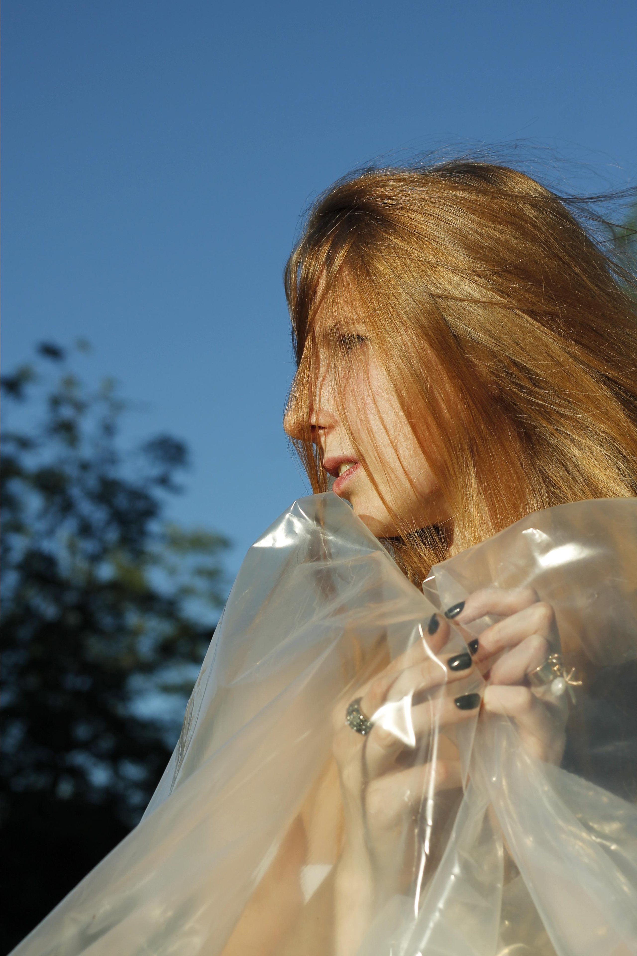 Woman with plastic cover by Anna Karamurzina