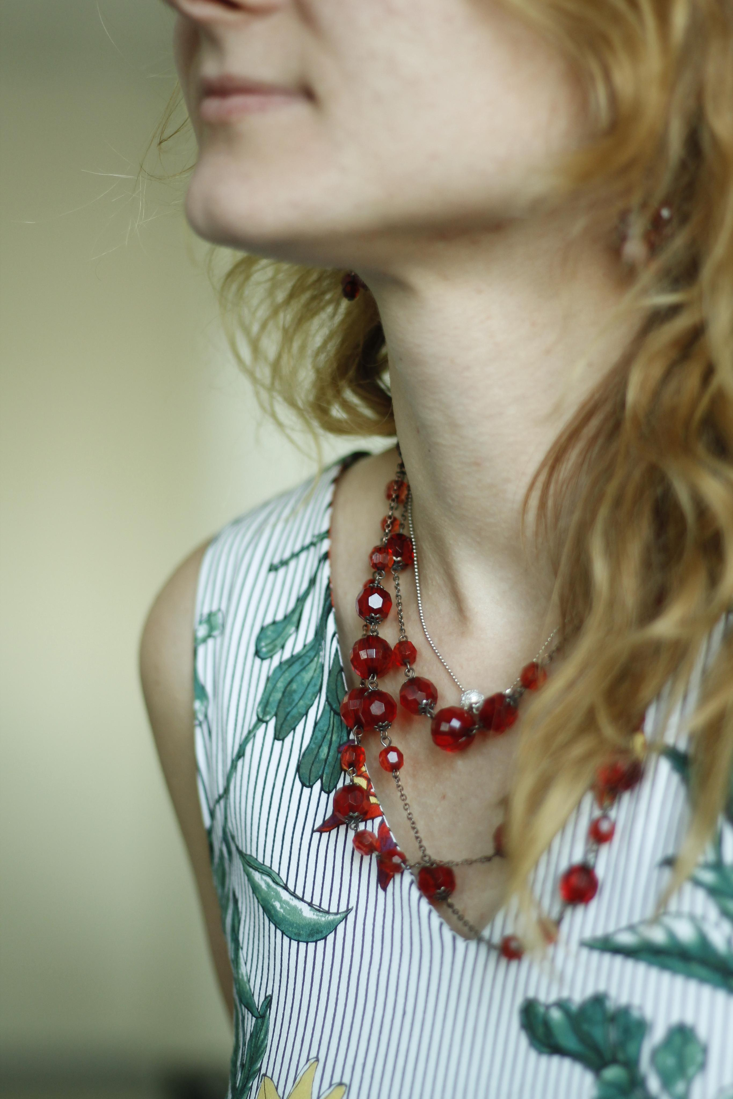 Neck of woman with red necklace
