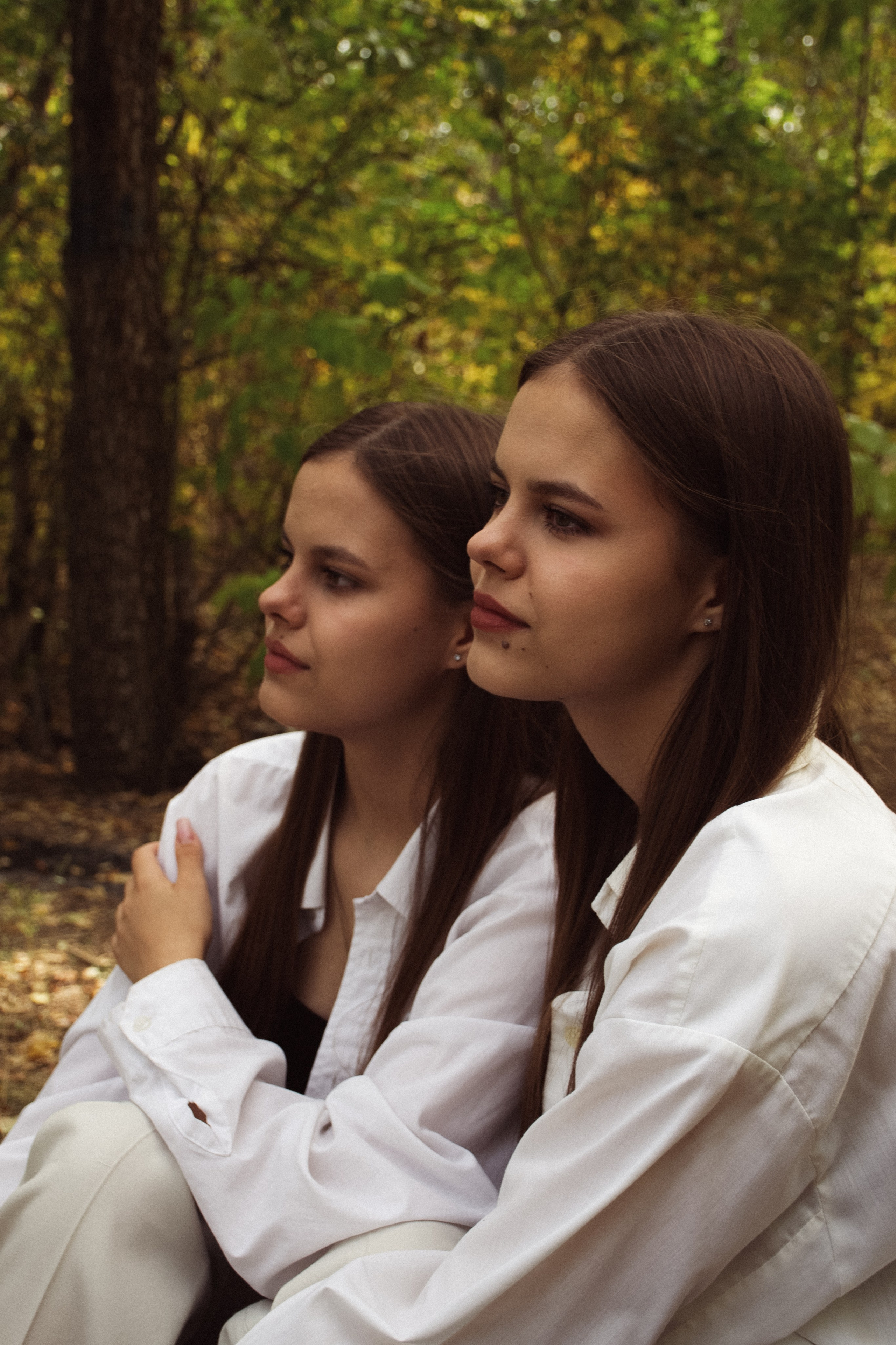 Сестры-близняшки на фоне весеннего парка в городе Волгоград