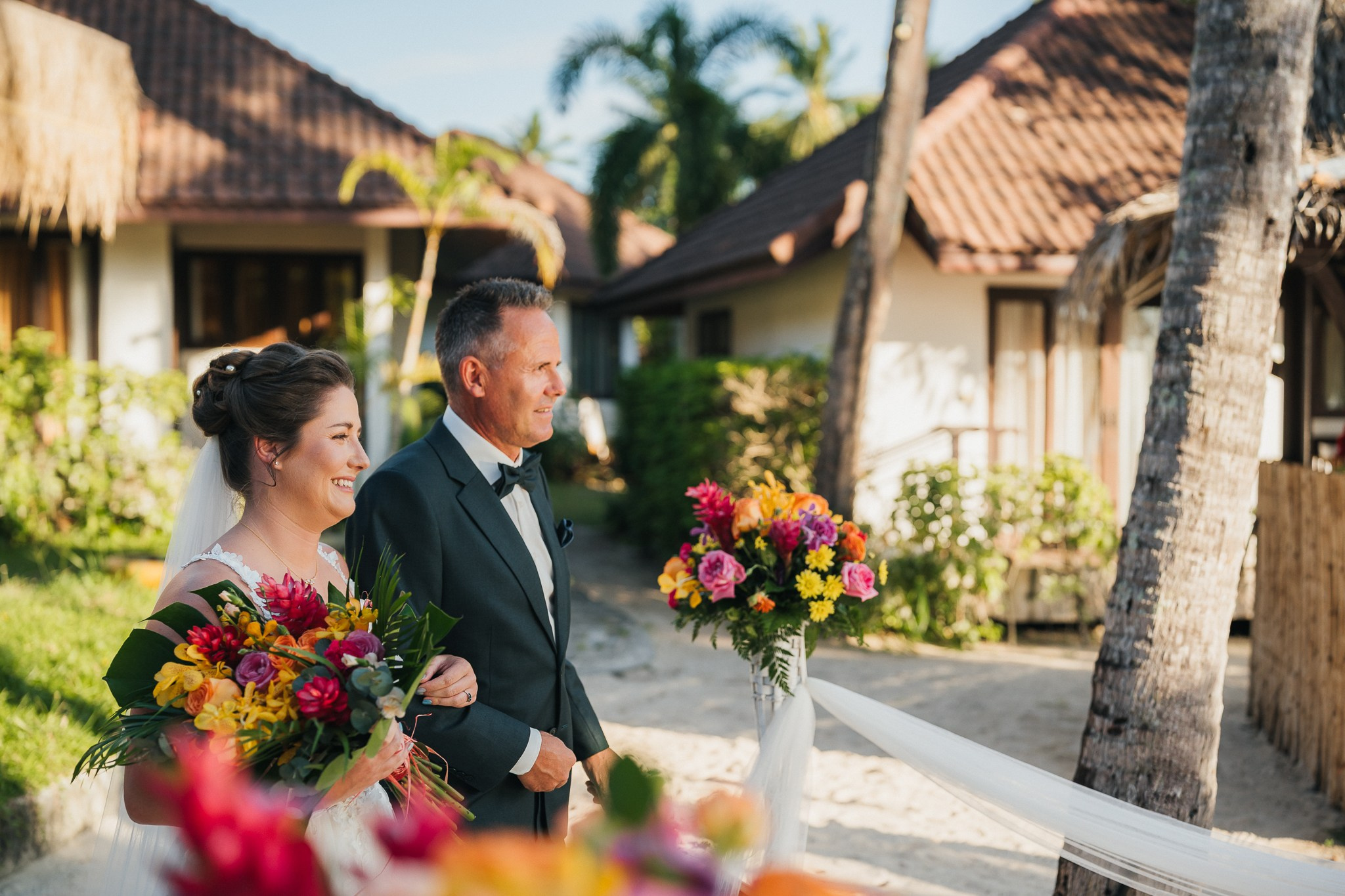 Destination beach wedding in Koh Samui, Thailand with the couple, family members and friends enjoying a tropical wedding ceremony by the sea