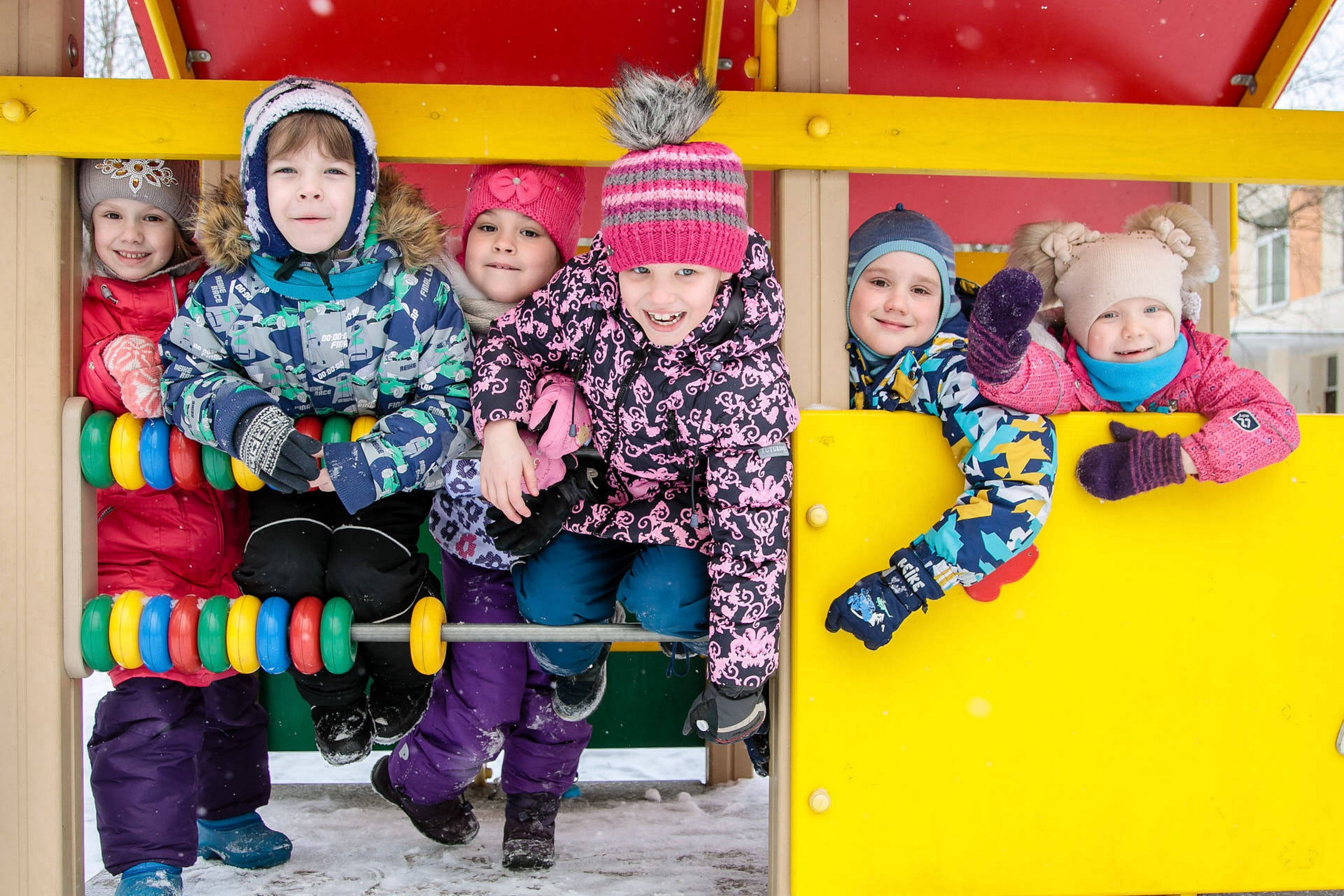 дети на прогулке зимой позируют и смеются