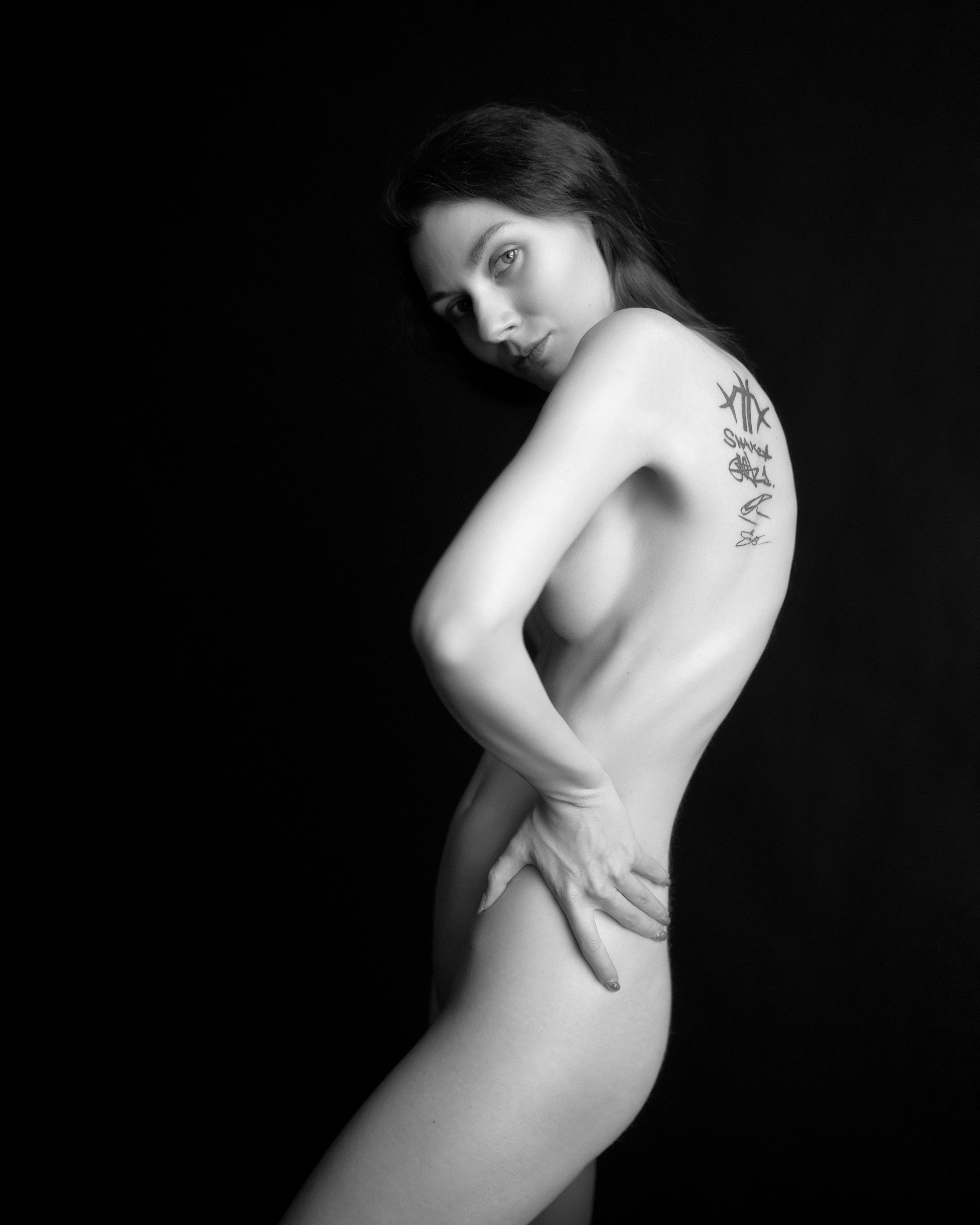A series of creative photos taken in the studio. The photos are made in the nude genre. Black and white photo