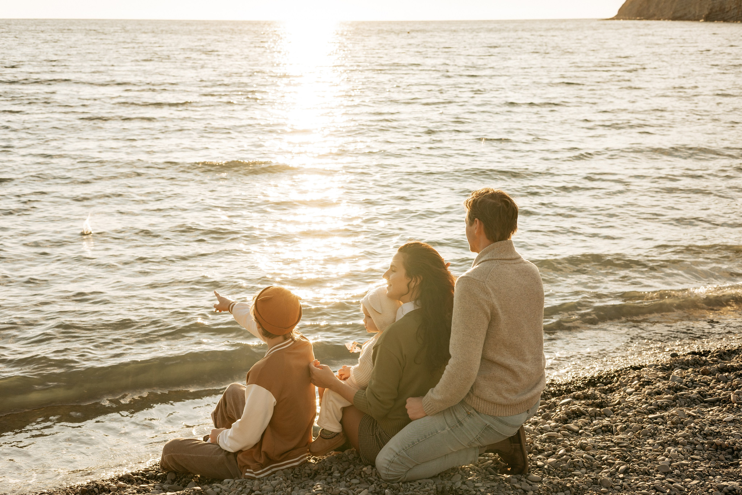 Семья из четырех человек наслаждается закатом вместе