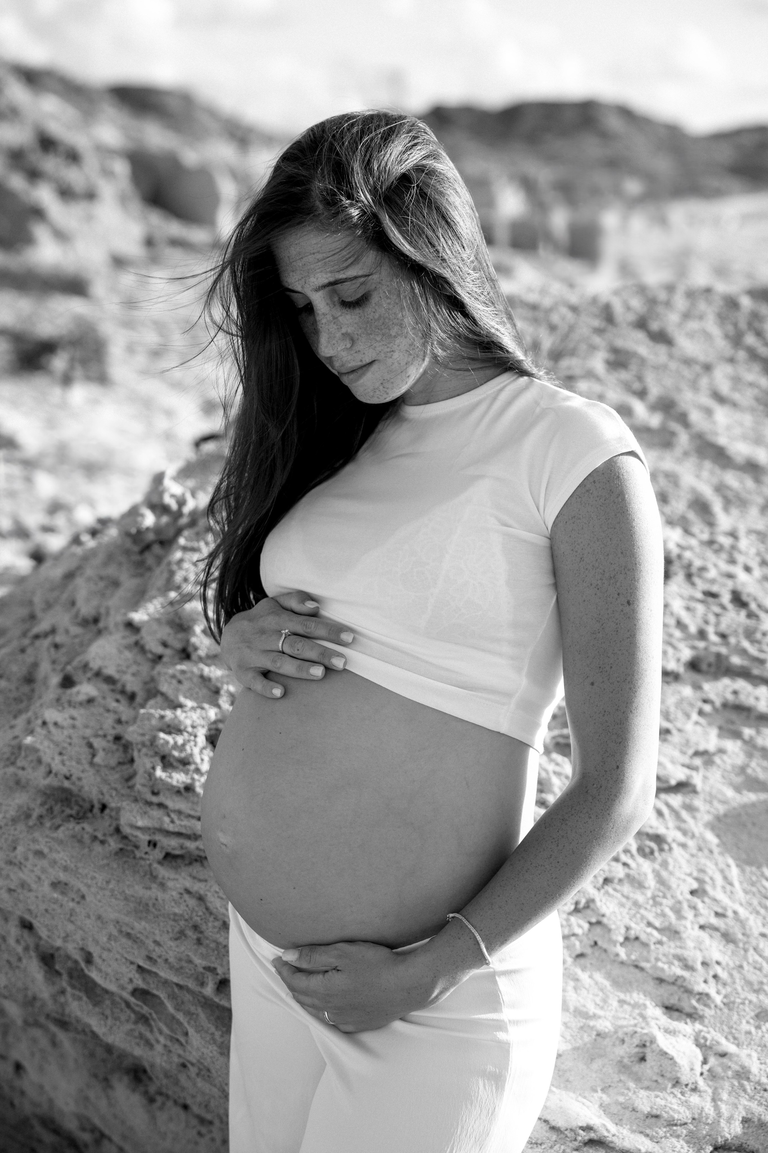 Pregnancy photoshoot near the sea. Wedding and family photographer