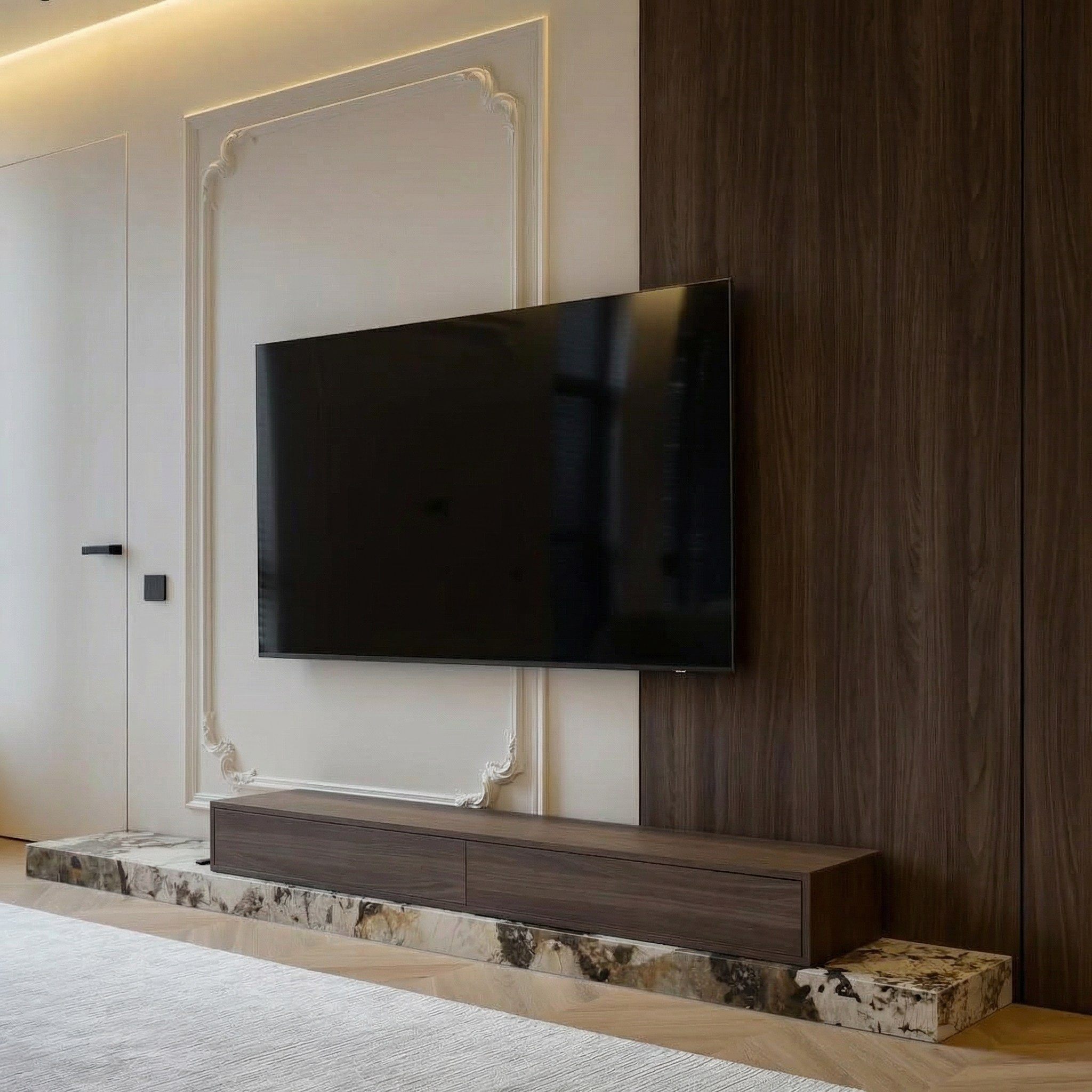 ТВ-зона в интерьере от Валерии Котович: сочетание неоклассических молдингов, шпонированных панелей и массивного основания из мрамора с ТВ-консолью в современной квартире.
