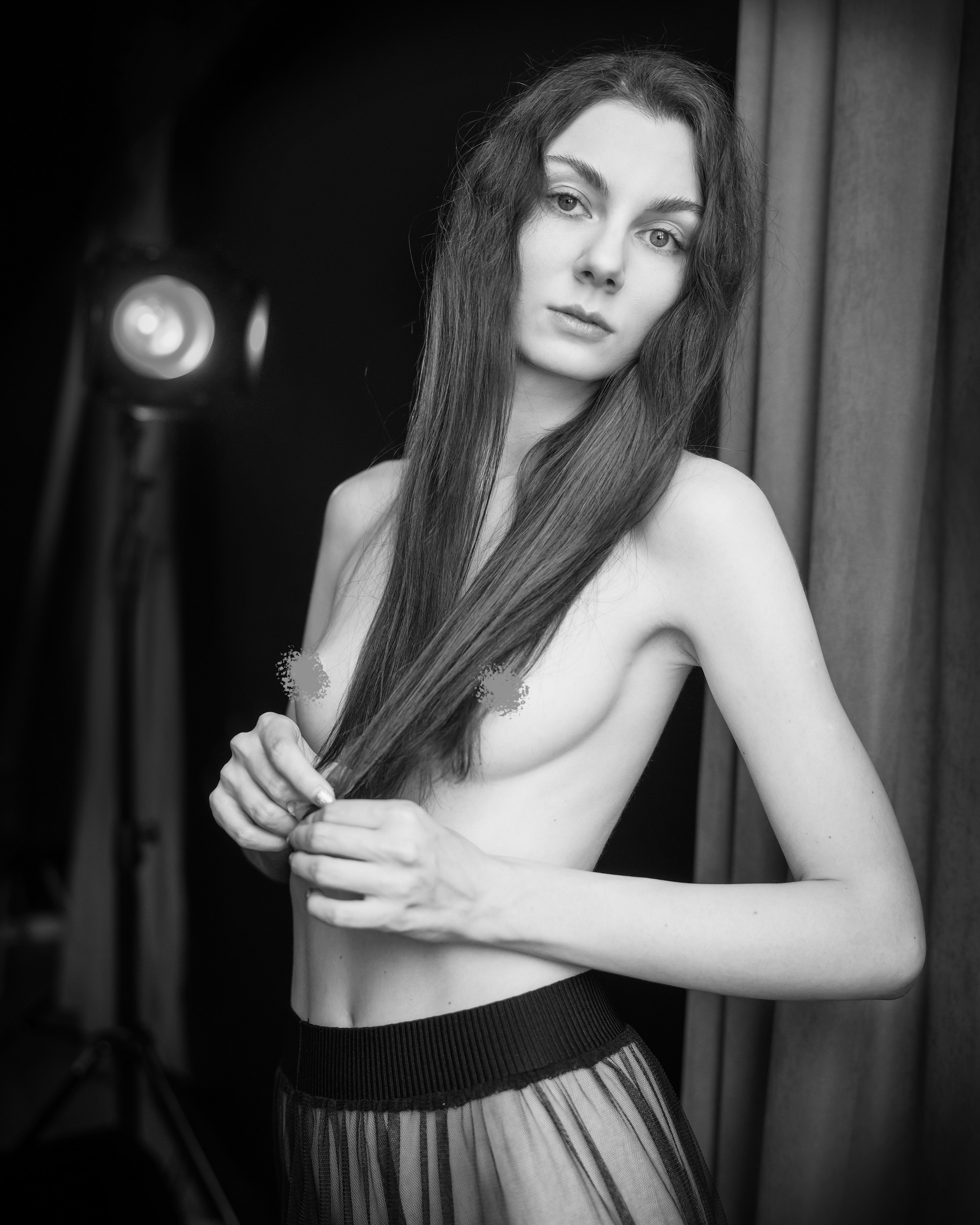 A series of creative photos taken in the studio. The photos are made in the nude genre. Black and white photo