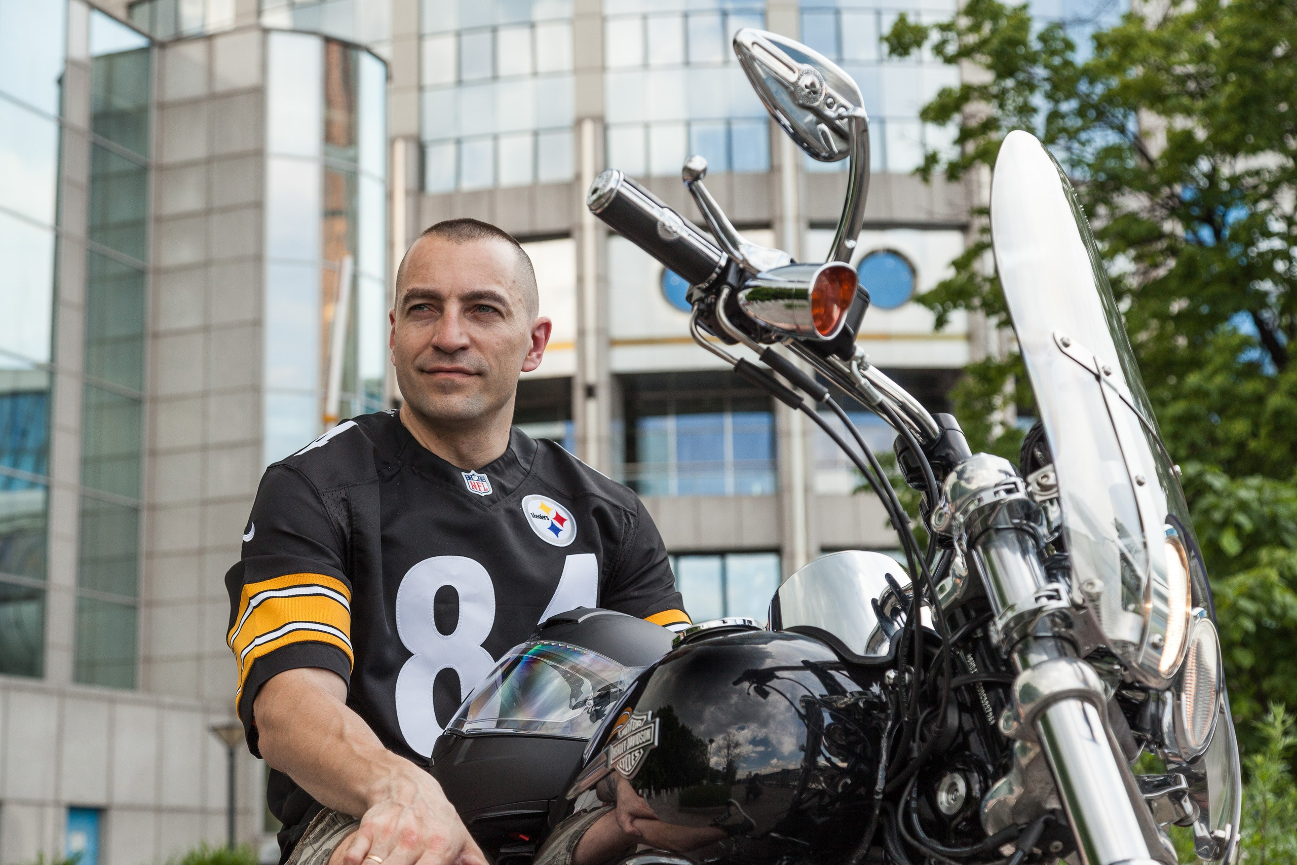 Location portrait of a biker on a Harley Davidson motorcycle in city landscape - photographer Andrey Dunin