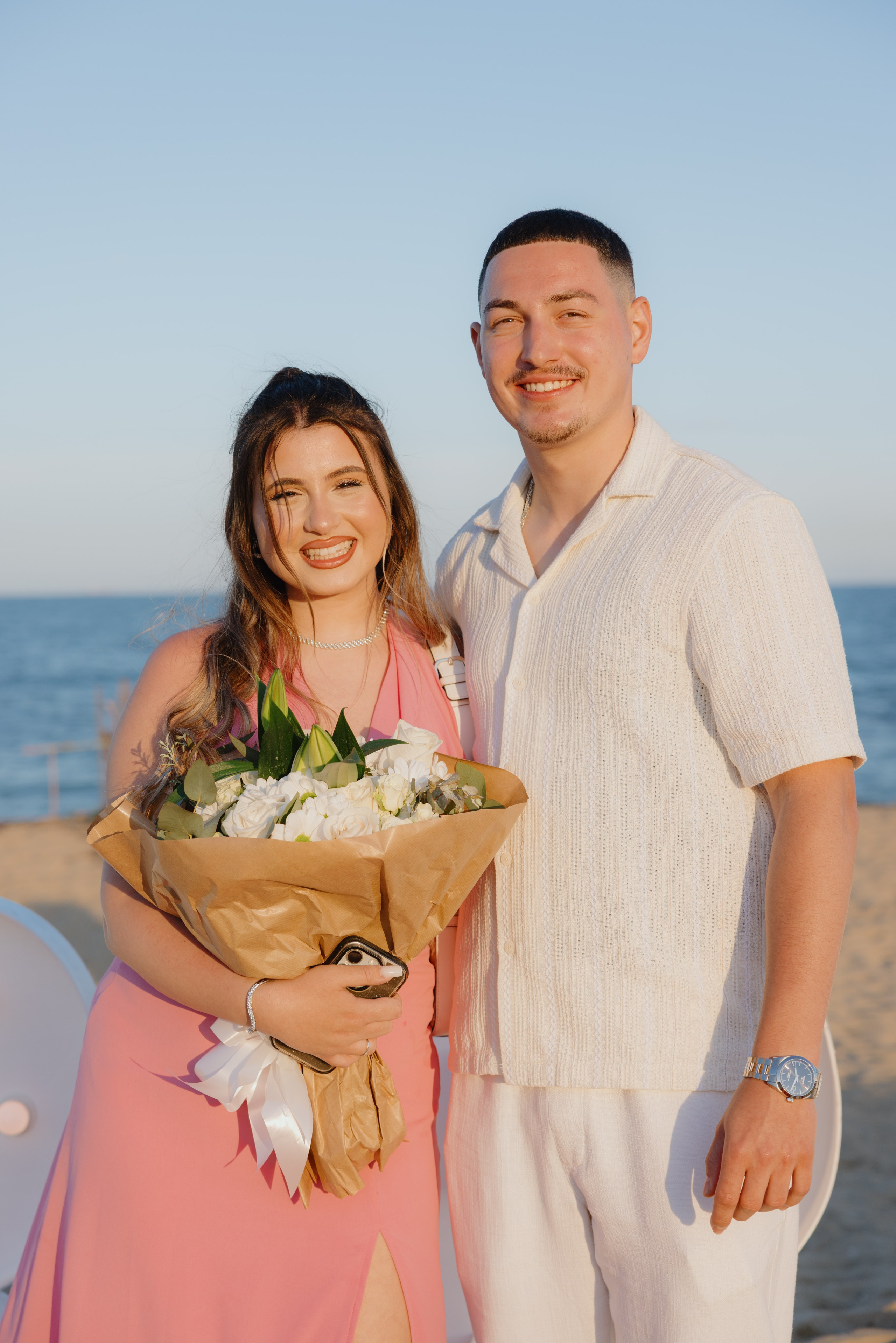 Romantic mountain-top proposal — man proposing with breathtaking view in the background