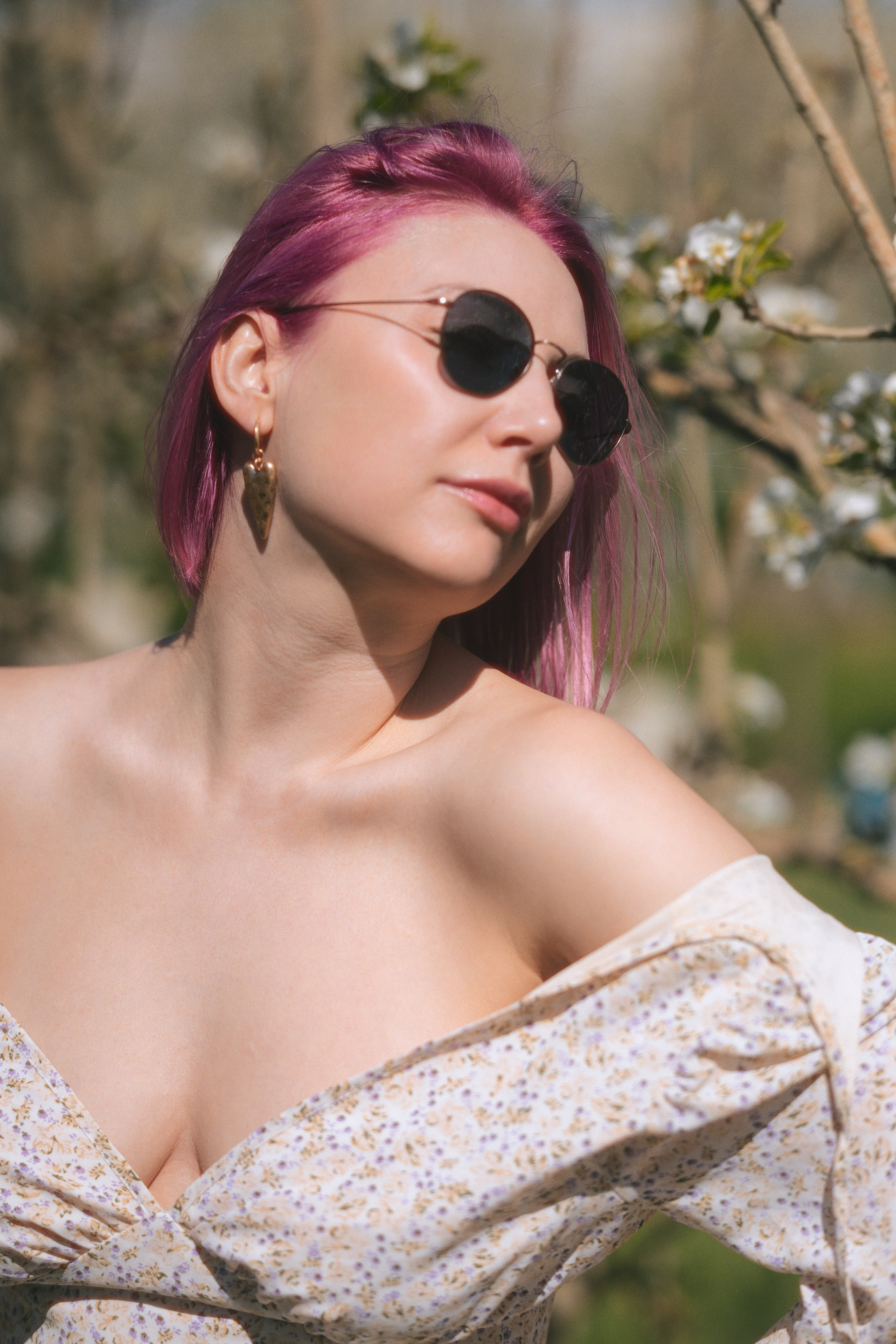 Woman in a flowing dress in a blooming garden, portrait photoshoot in Barcelona with soft natural light