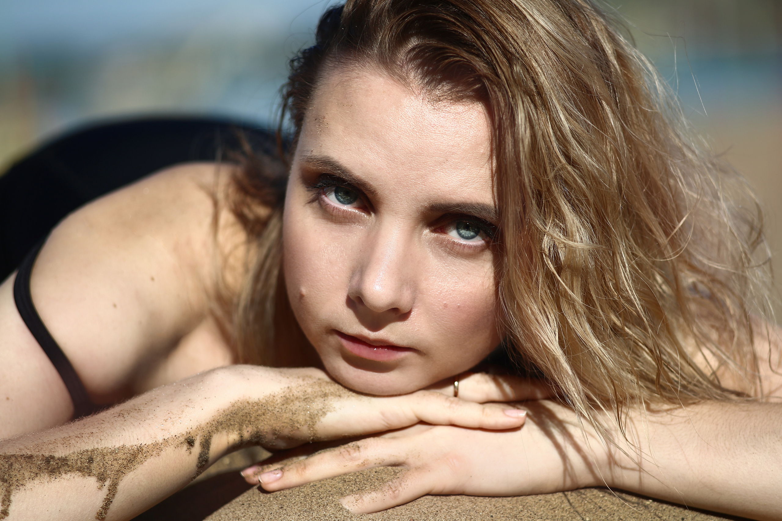 Светловолосая молодая девушка на песке