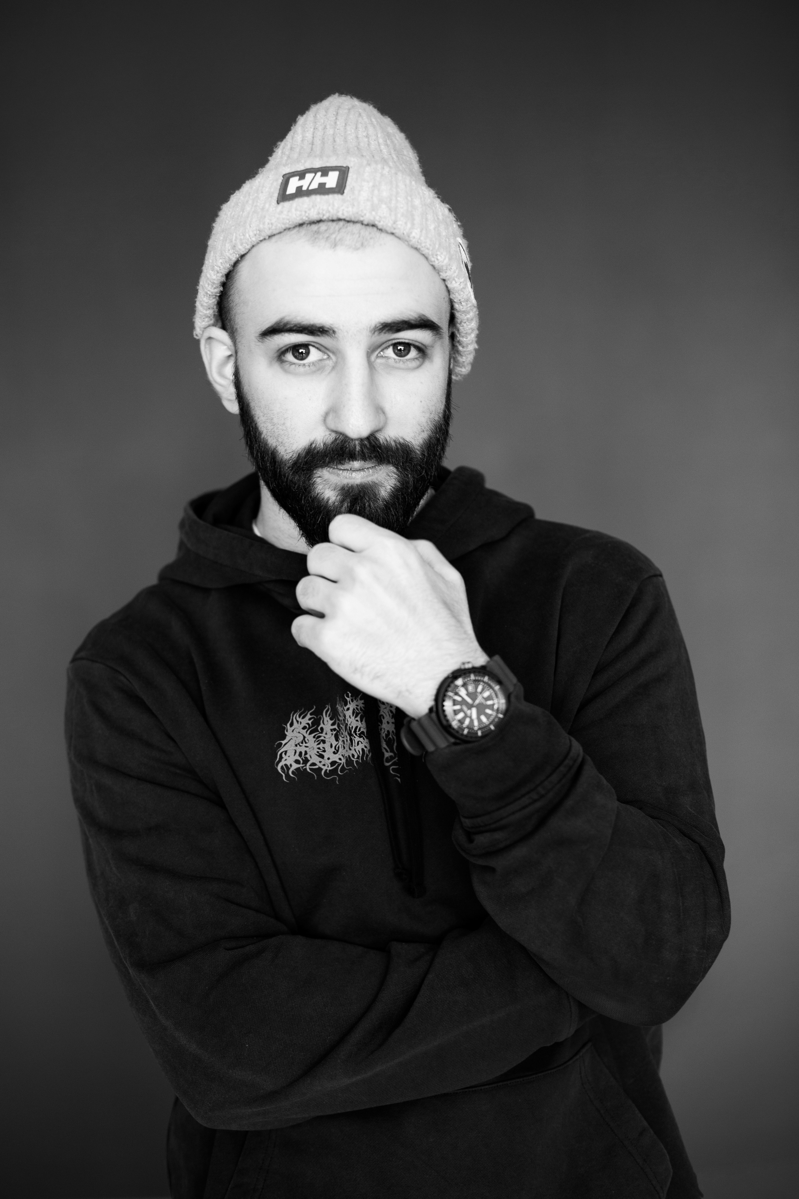 Парень с бородой и в вязанной шапке на голове