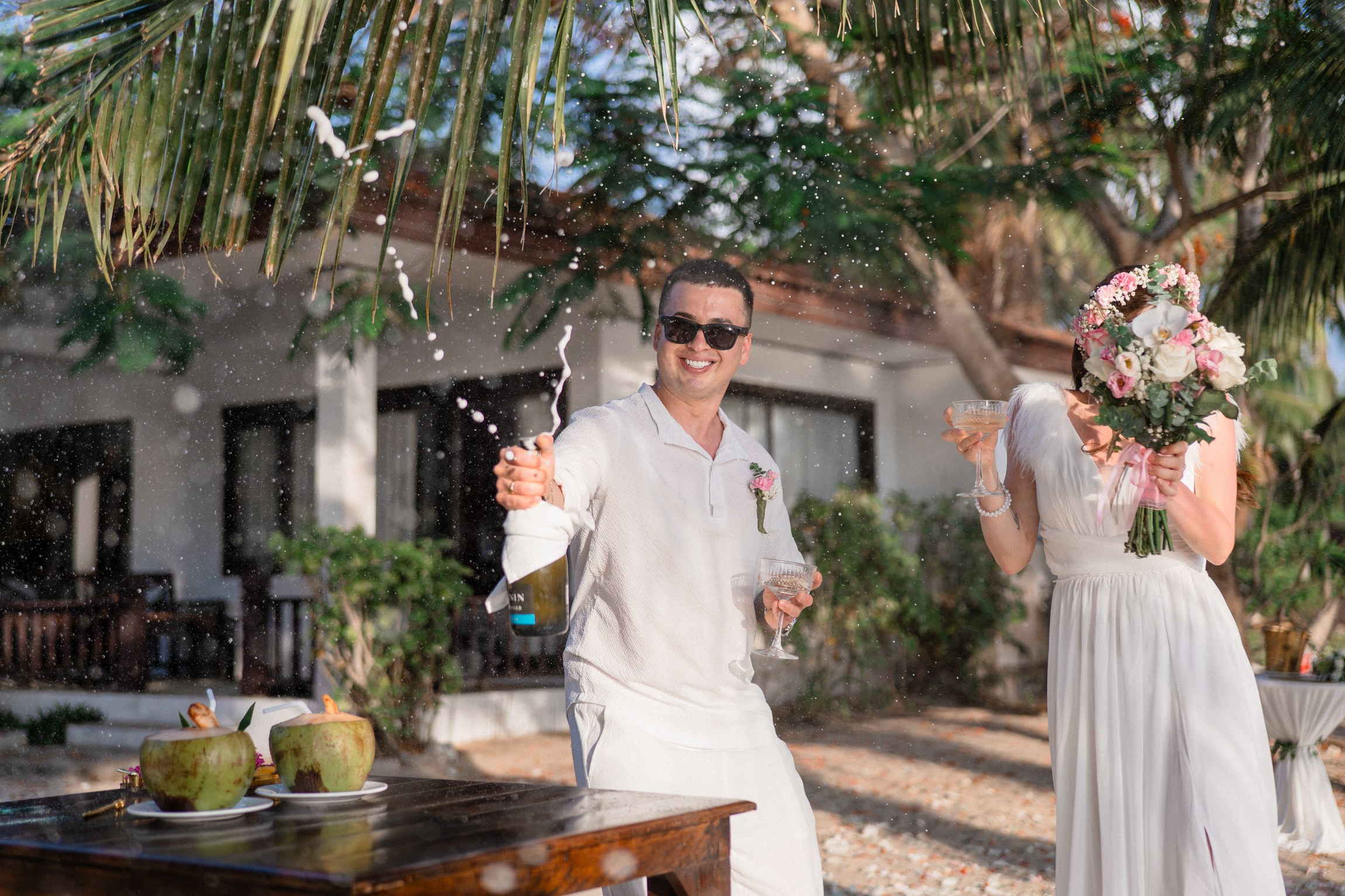 Bride and groom during a romantic beach wedding ceremony on Koh Samui, Thailand, surrounded by tropical scenery and ocean views