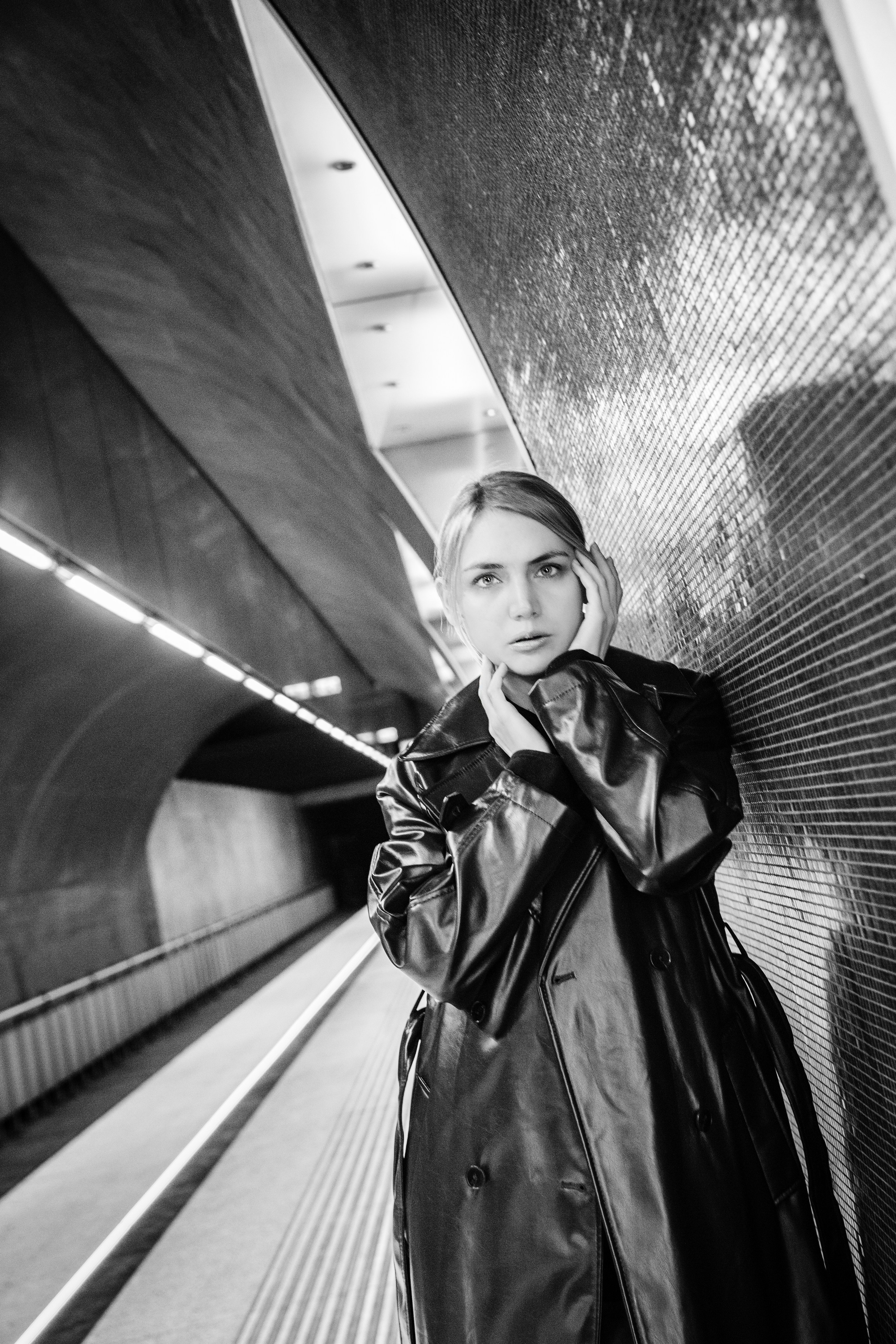 A black and white photograph of a girl on the Budapest metro