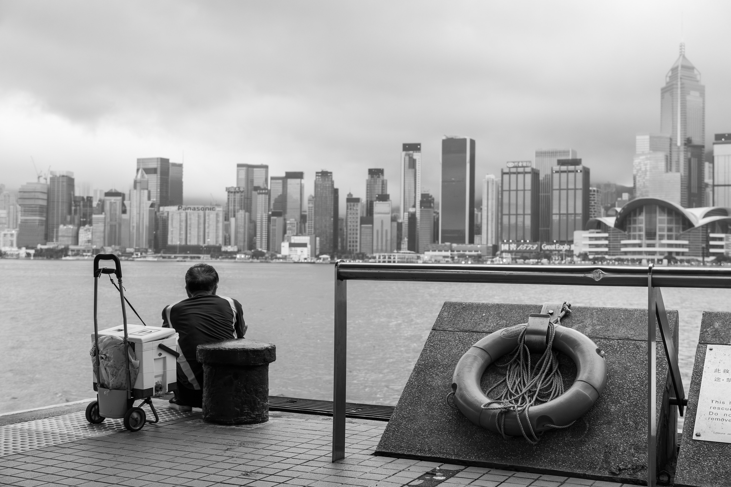 Man is fishing in Hong Kong. 