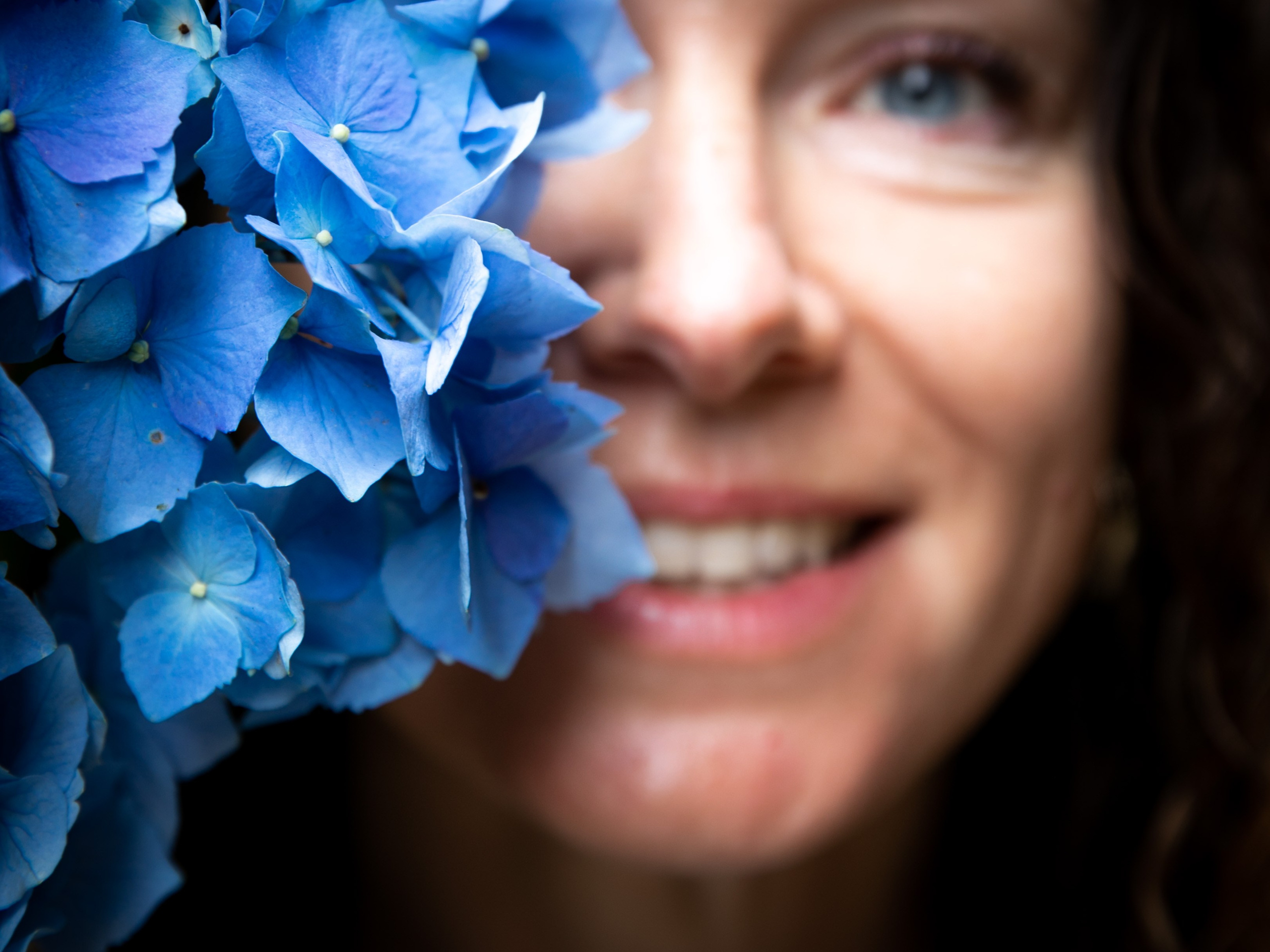 A serene moment of a woman surrounded by colourful flowers on the Azores