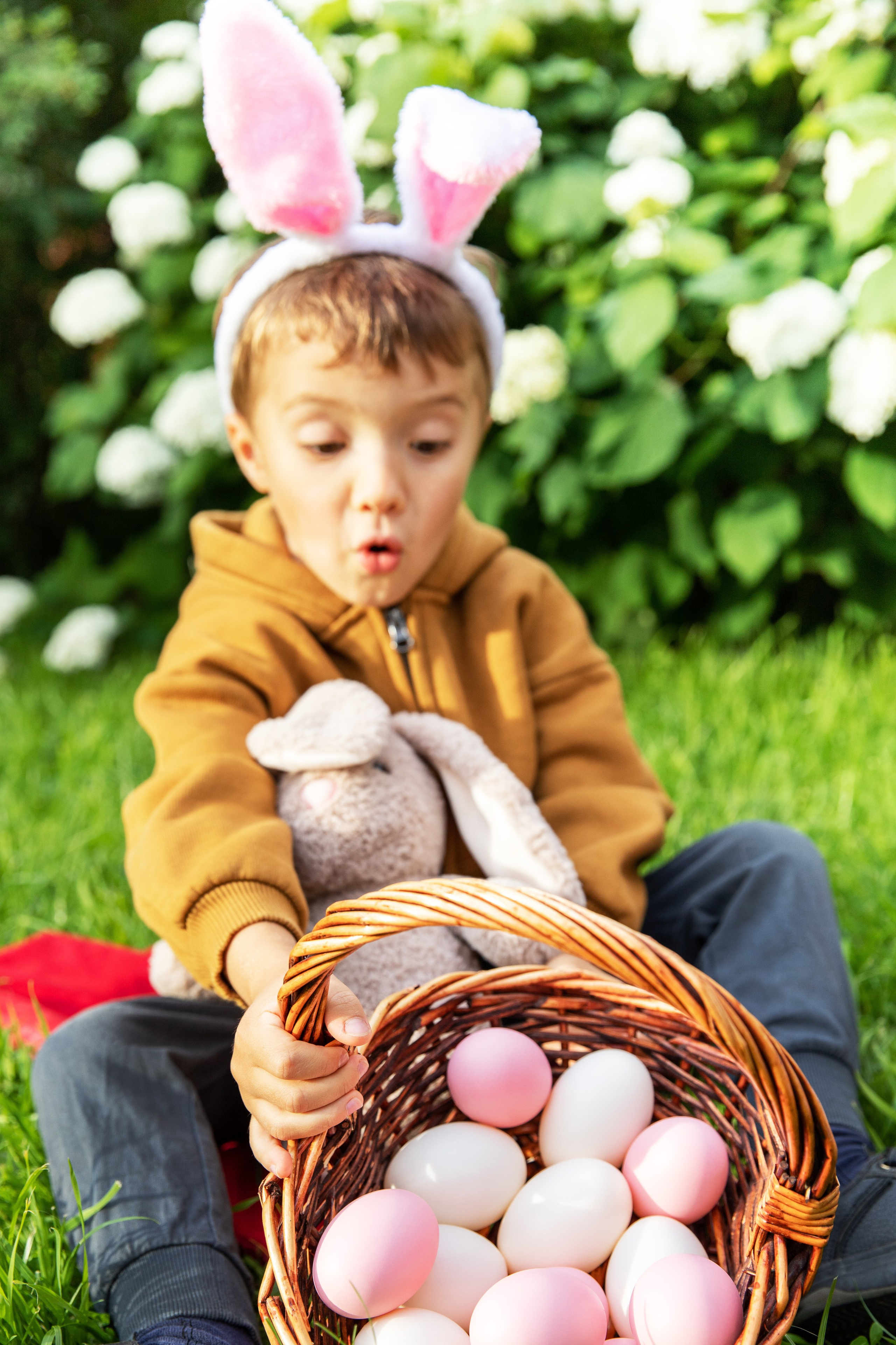 Children with bunny ears and coloured eggs