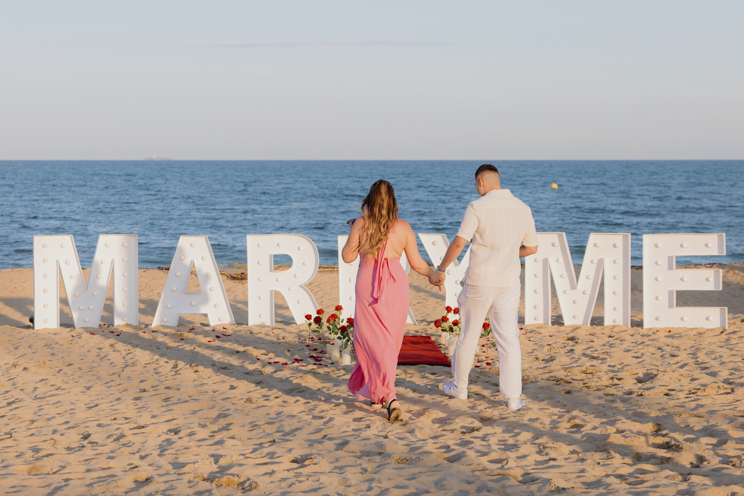 Emotional reaction to a proposal — woman covers her face in happy tears.