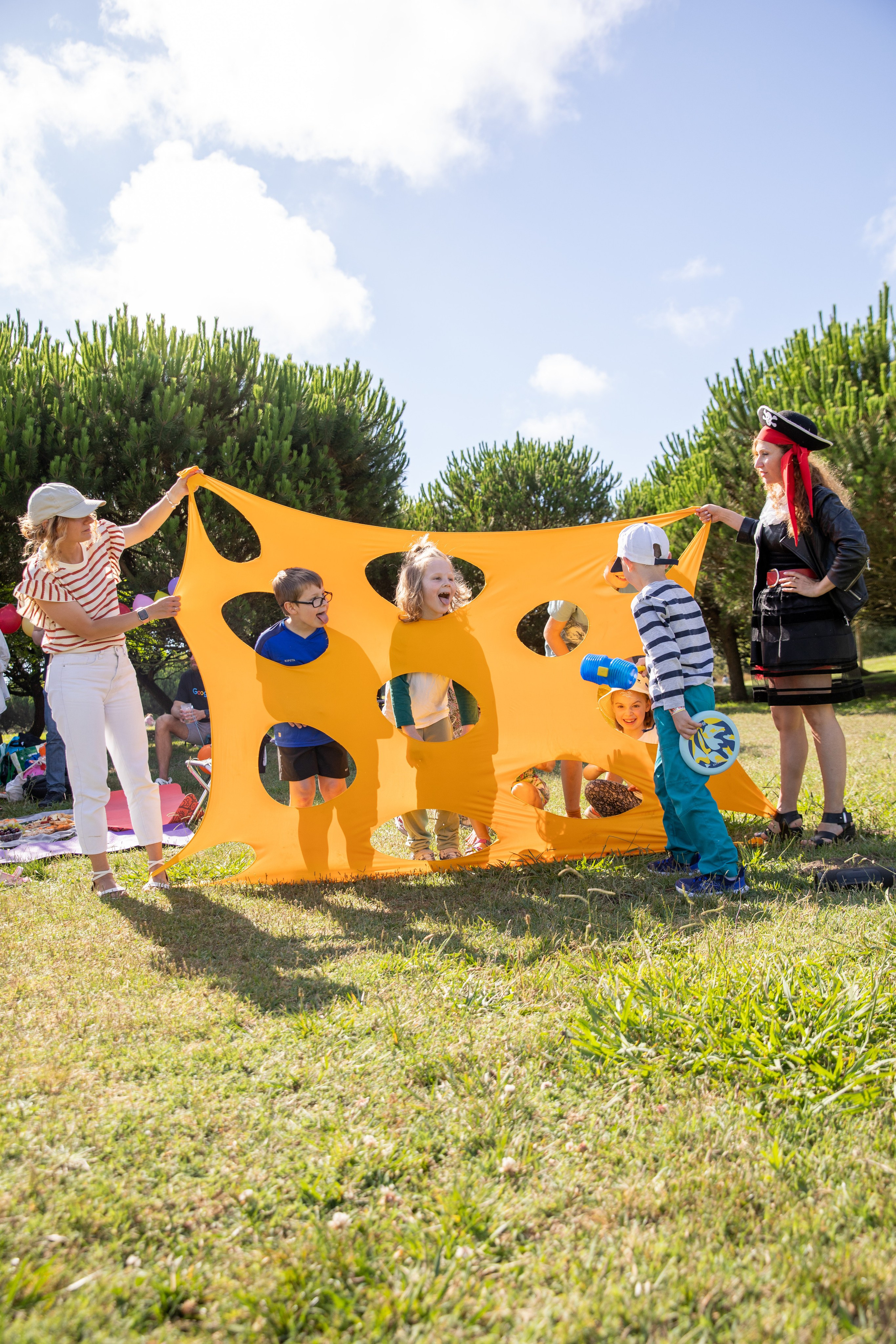 Fun birthday photo shoot in the park with kids playing and bubbles floating around