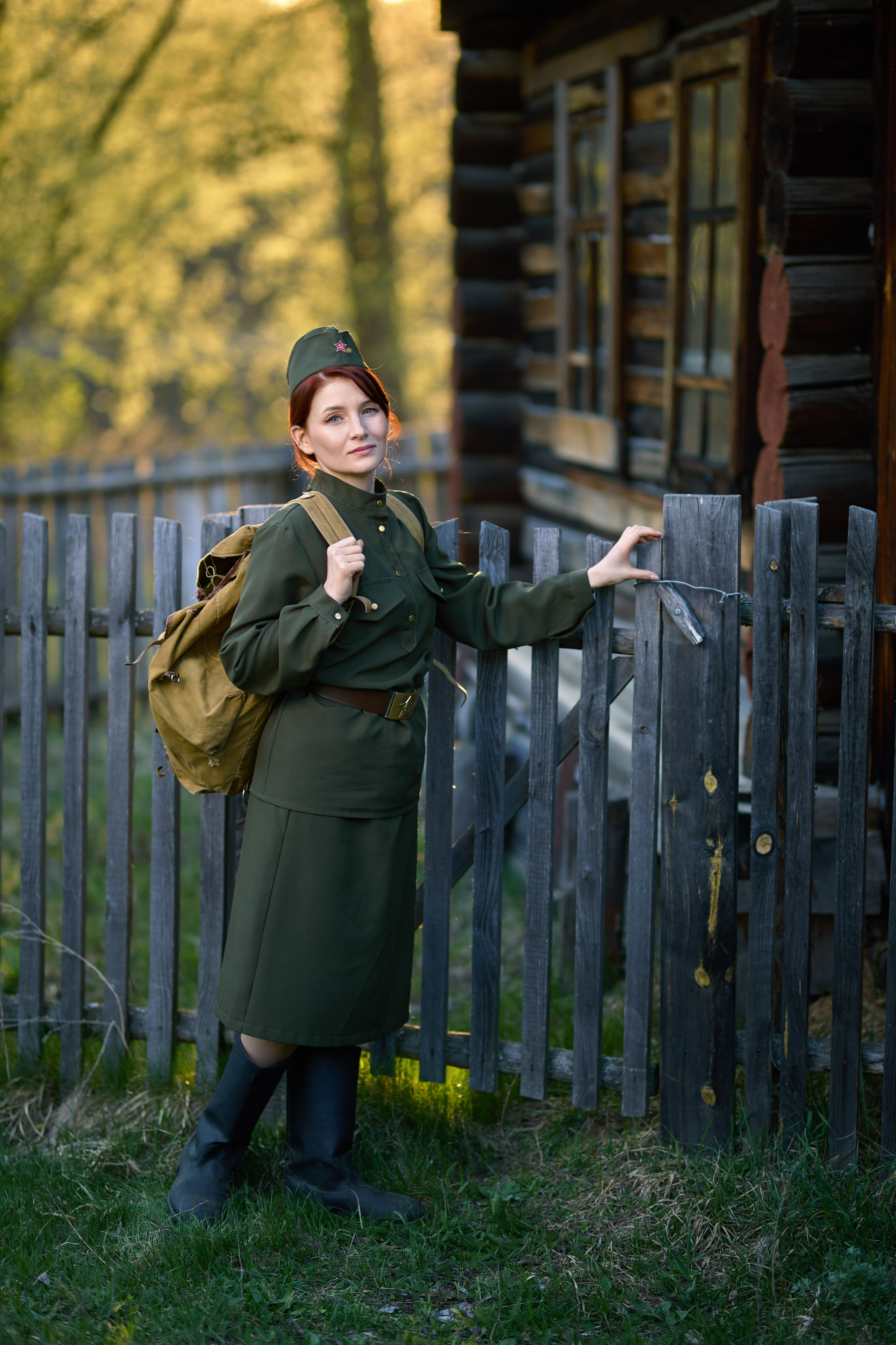 тематическая фотосессия на военную тему, девушка стоит  у  забора