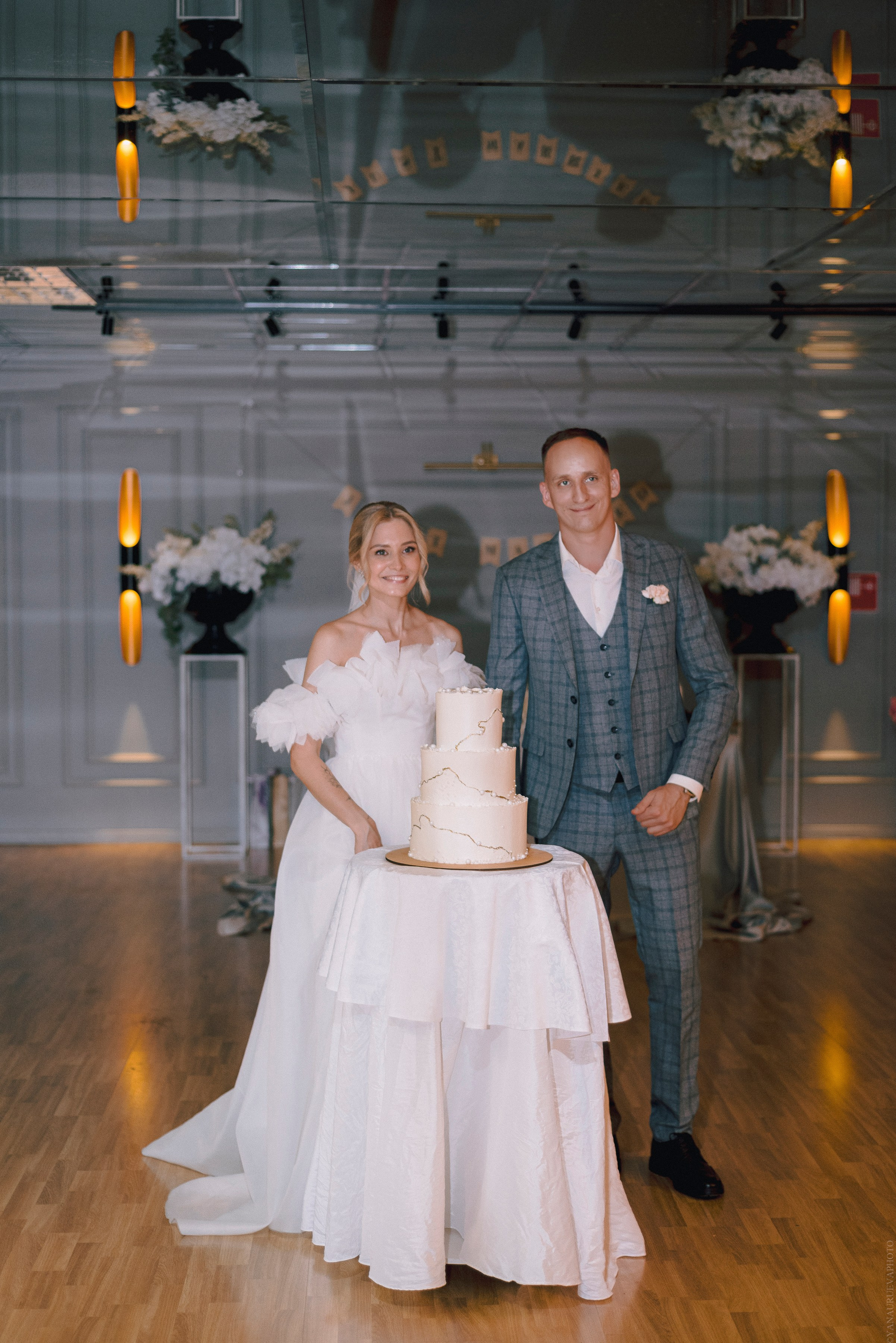 Свадебный торт и молодожены на фоне