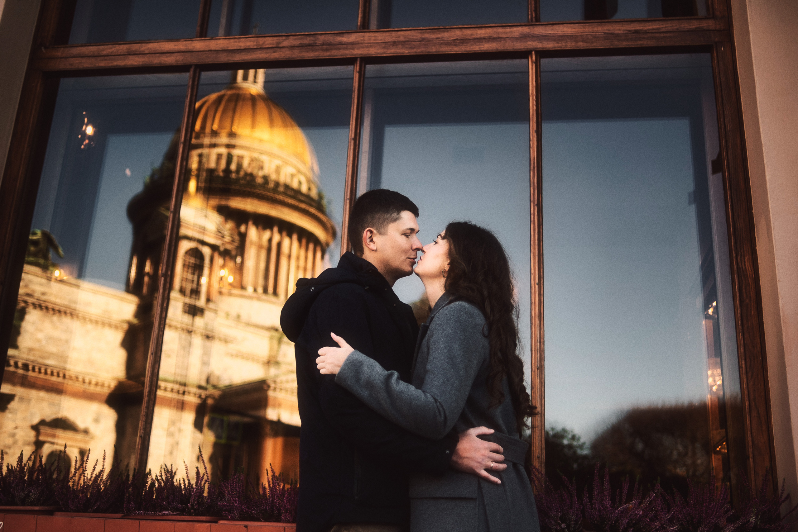 Влюбленная пара целуется на фоне Иссакиевского собора в Санкт-Петербурге