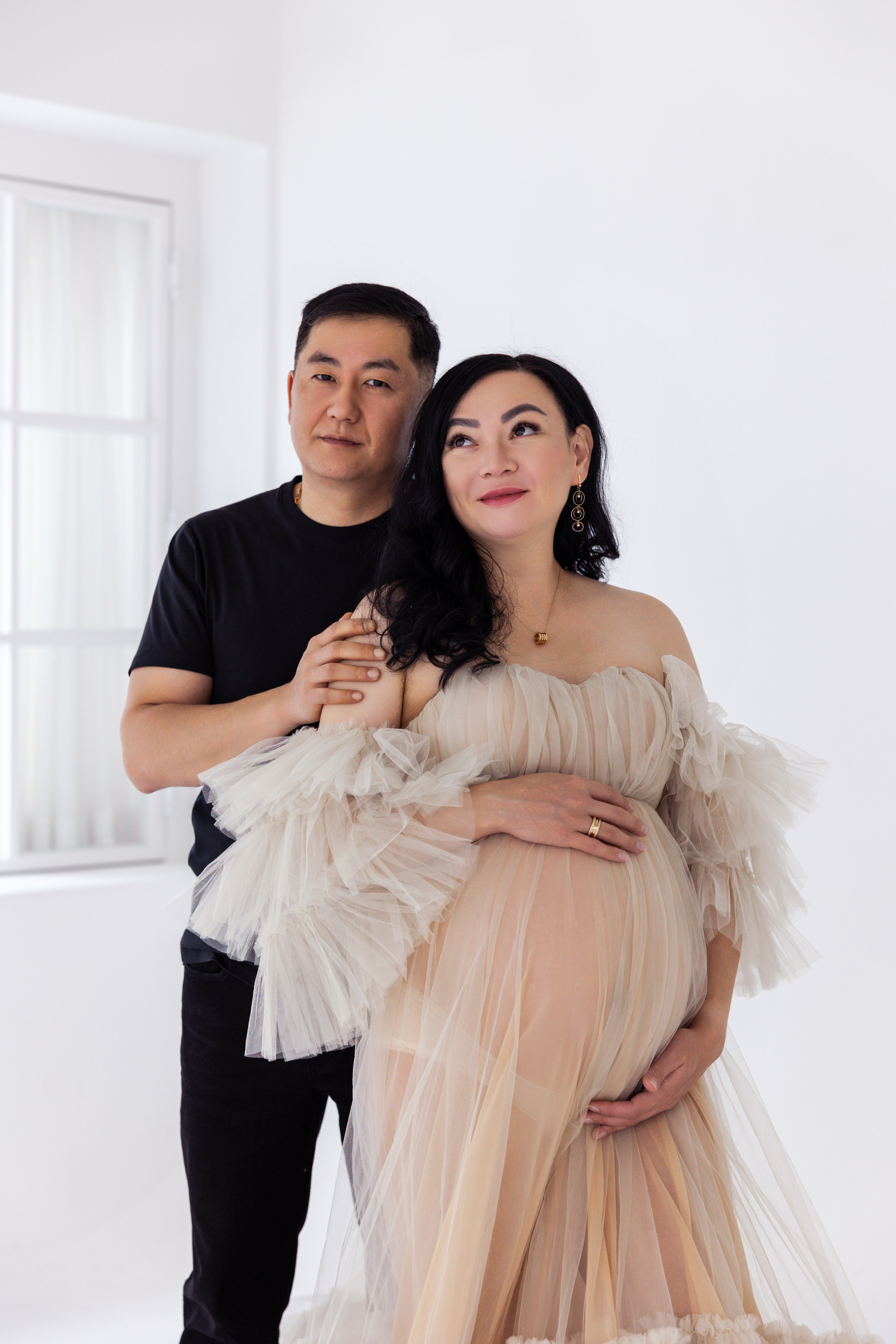 Pregnancy photo session with husband in studio