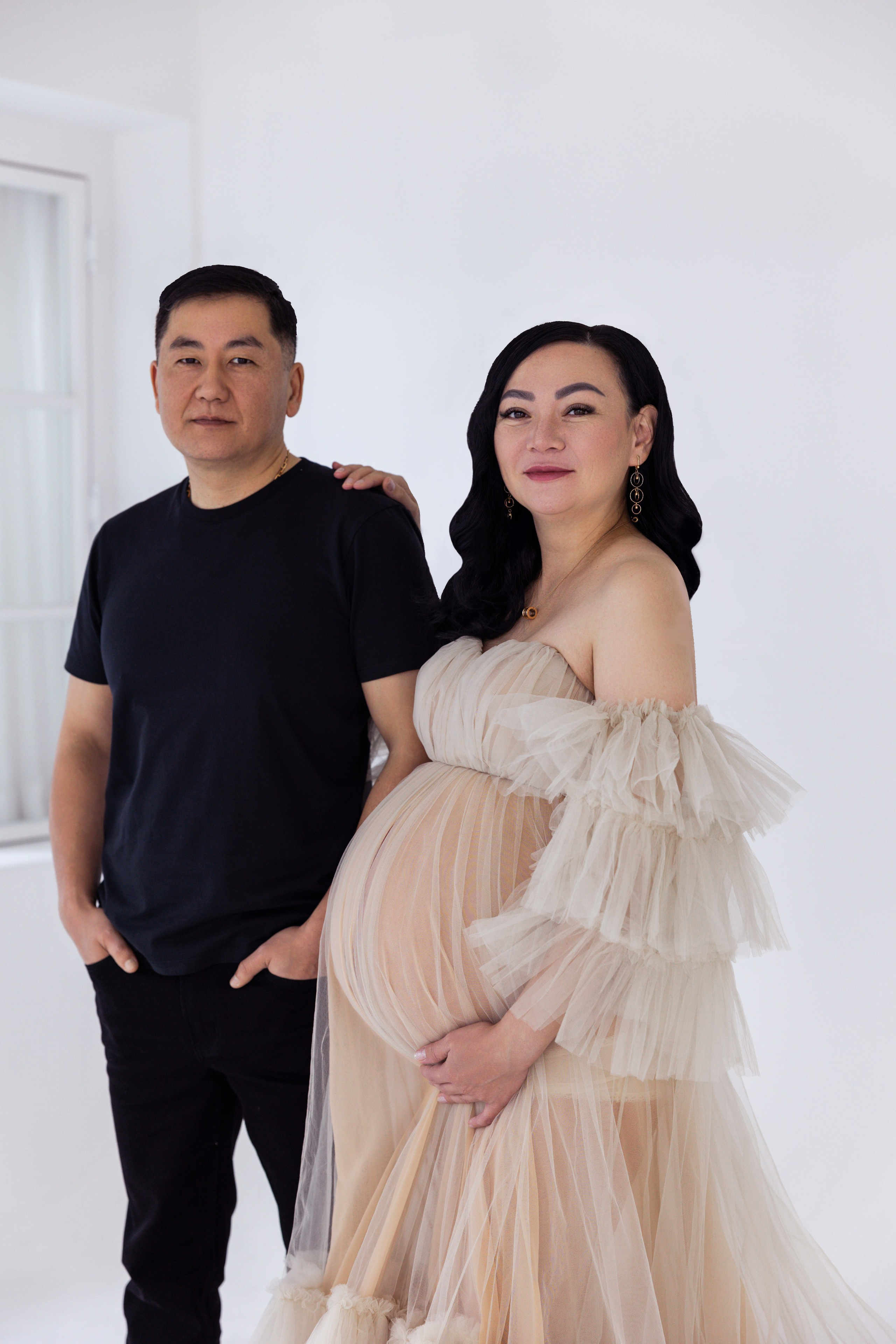 Pregnancy photo session with husband in studio