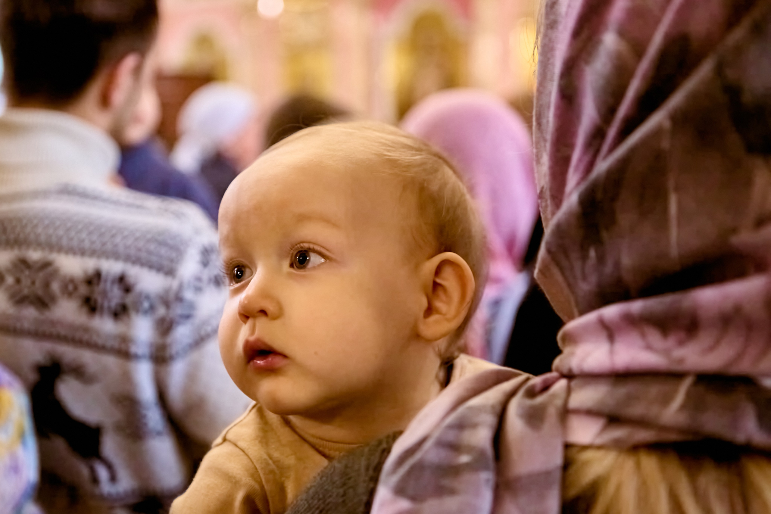 На руках у мамы малыш. Изучающий взгляд.