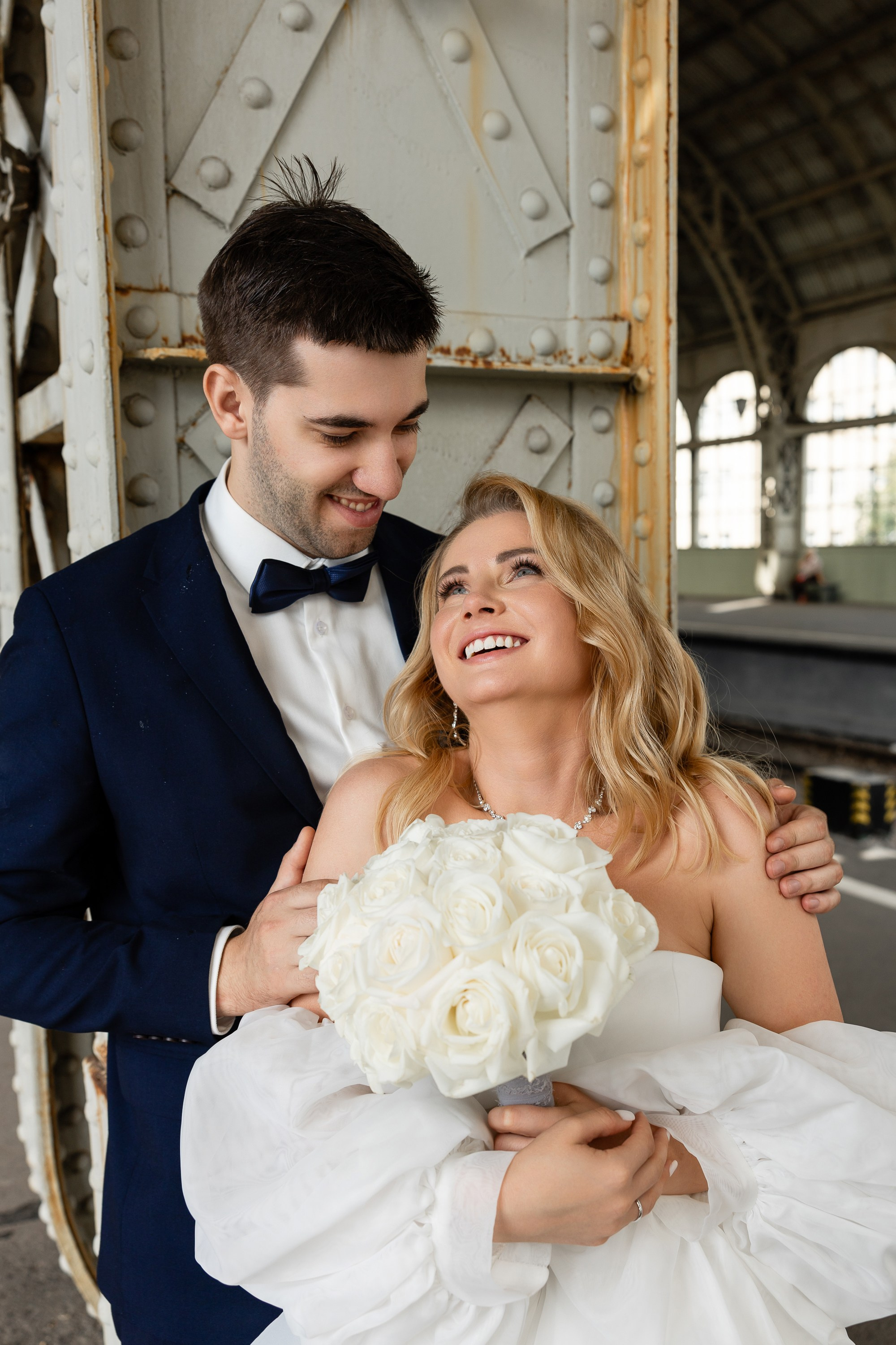 Молодожены нежно смотрят друг на дуга на перроне Витебского вокзала