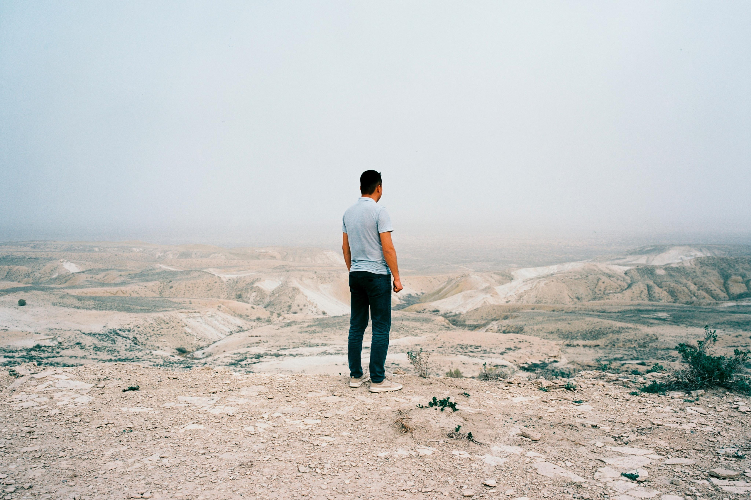 A man is looking at the desert where the sea used to be