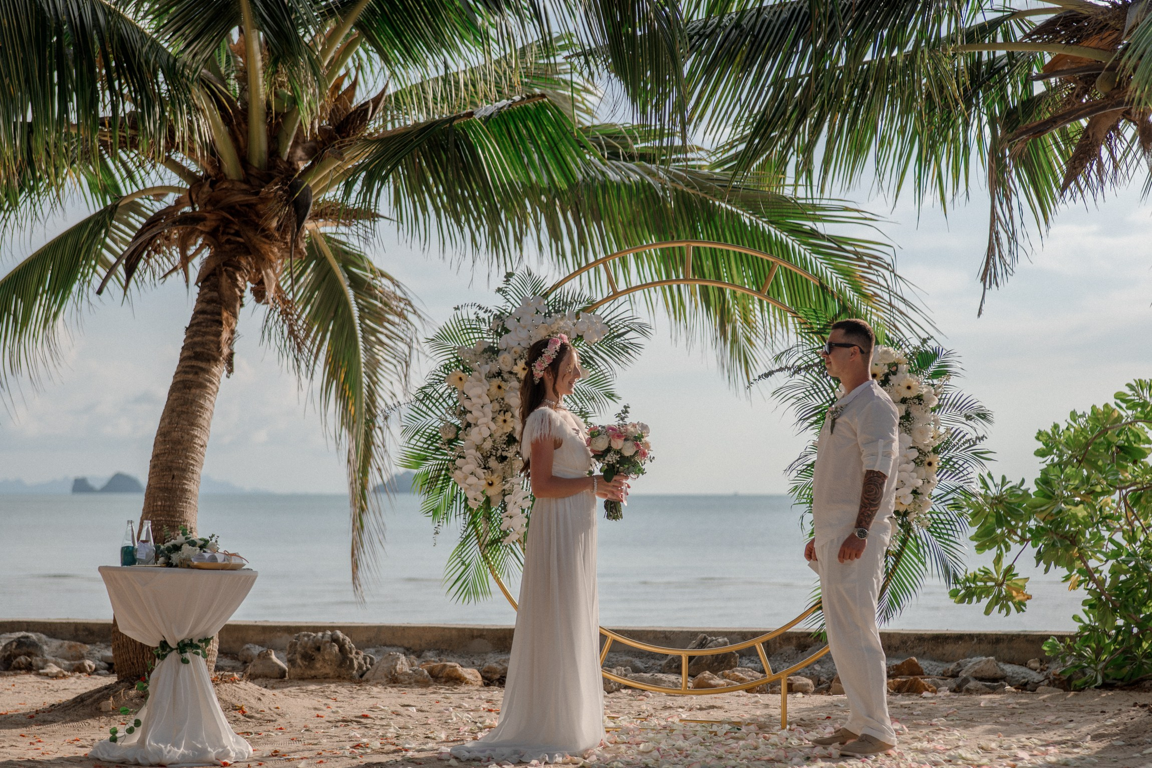 Bride and groom during a romantic beach wedding ceremony on Koh Samui, Thailand, surrounded by tropical scenery and ocean views