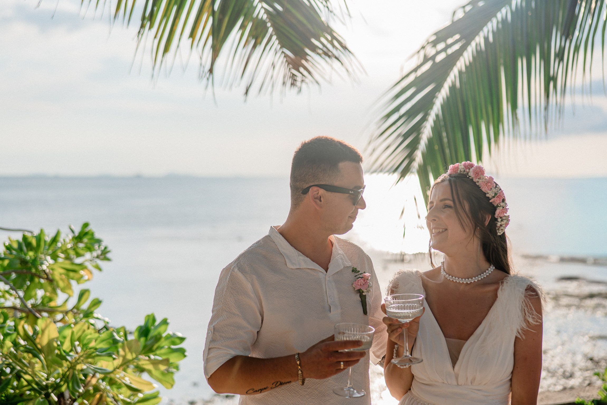 Bride and groom exchanging vows on a private sunset beach