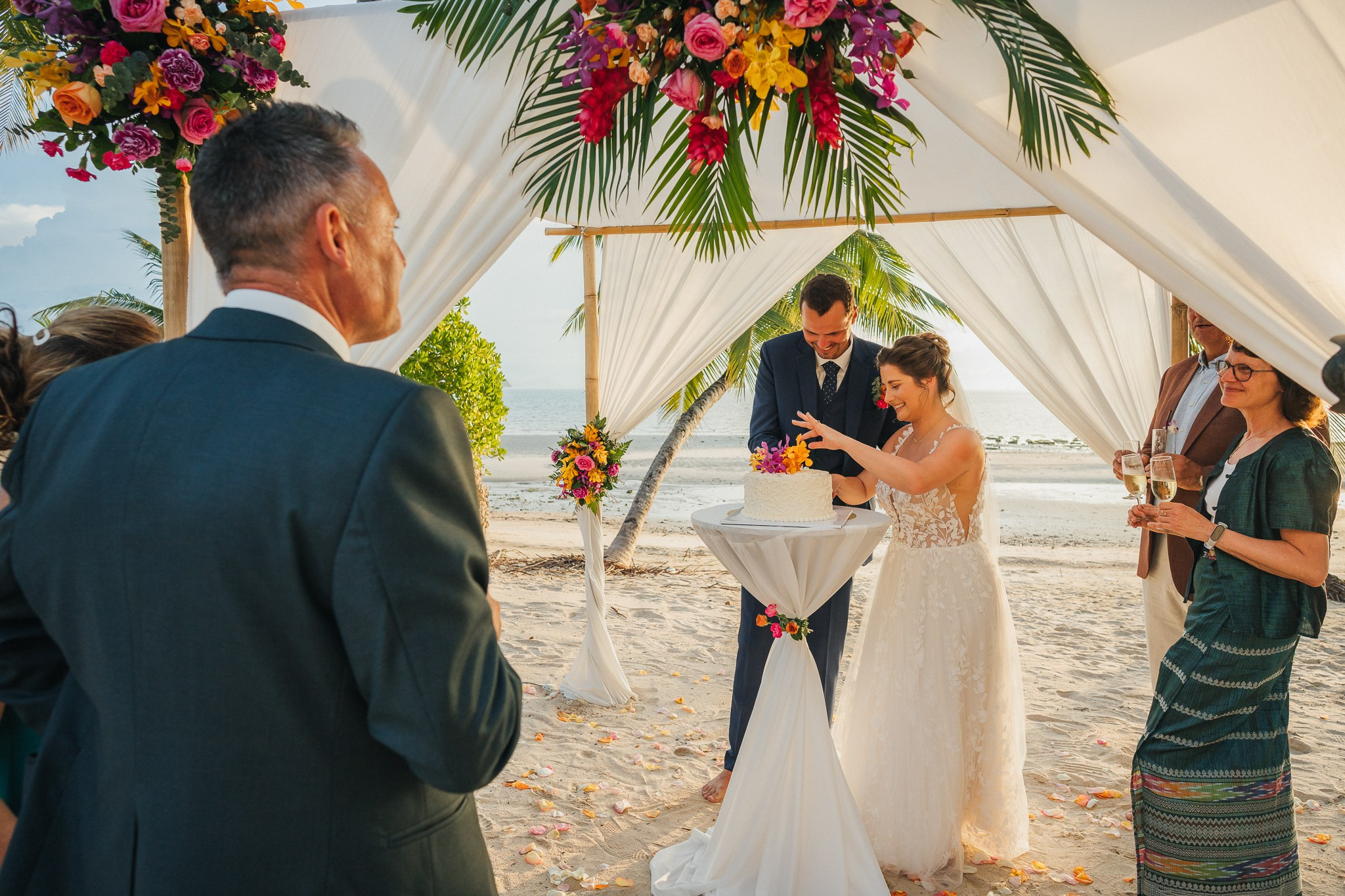 Destination beach wedding in Koh Samui, Thailand with the couple, family members and friends enjoying a tropical wedding ceremony by the sea