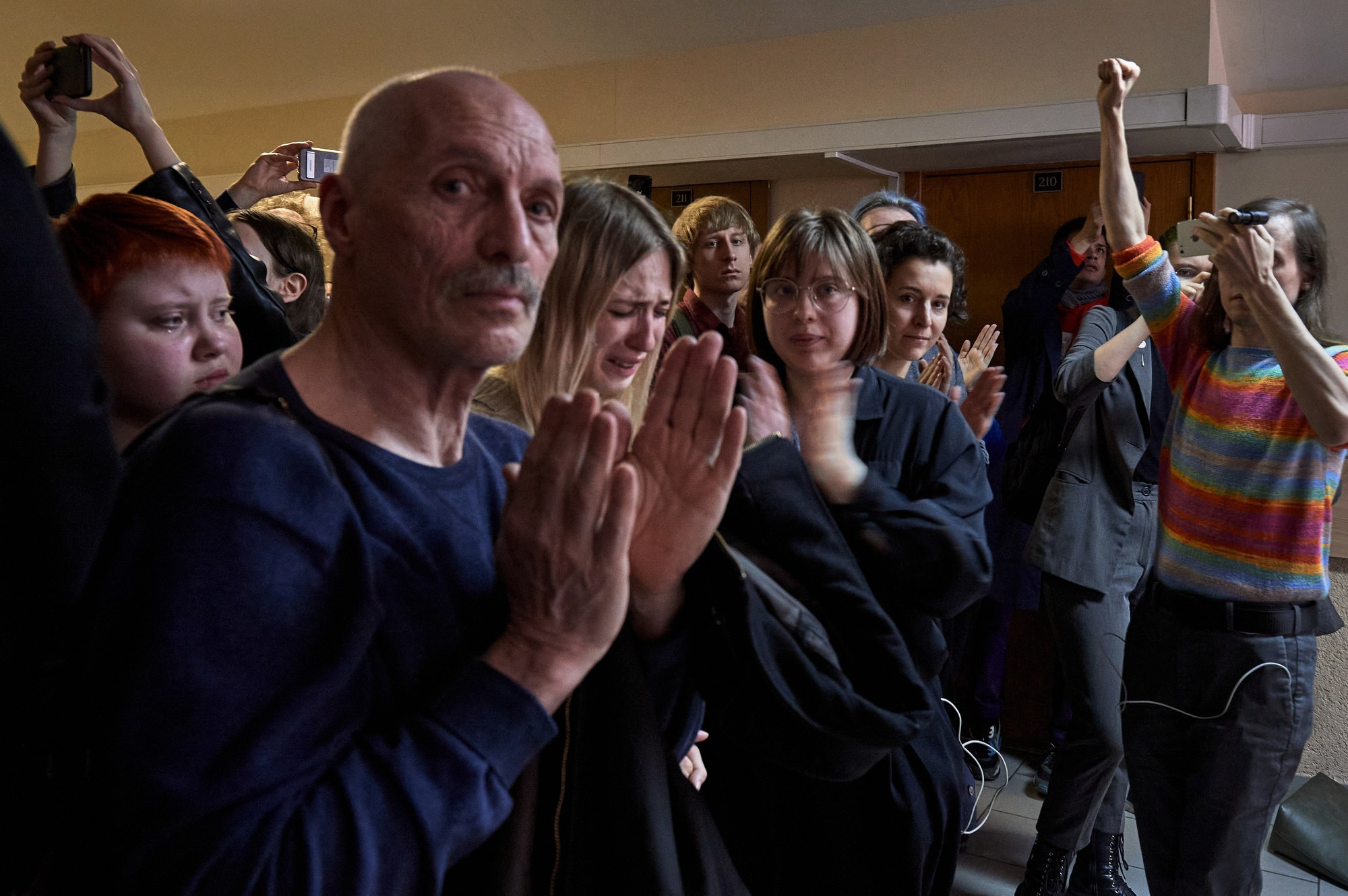 Sasha's close friends and her girlfriend Sonya, who is in tears (center), applaud as Sasha is led out of the courtroom by the convoy to be taken to pre-trial detention. Sasha's trials always drew large crowds of supporters.