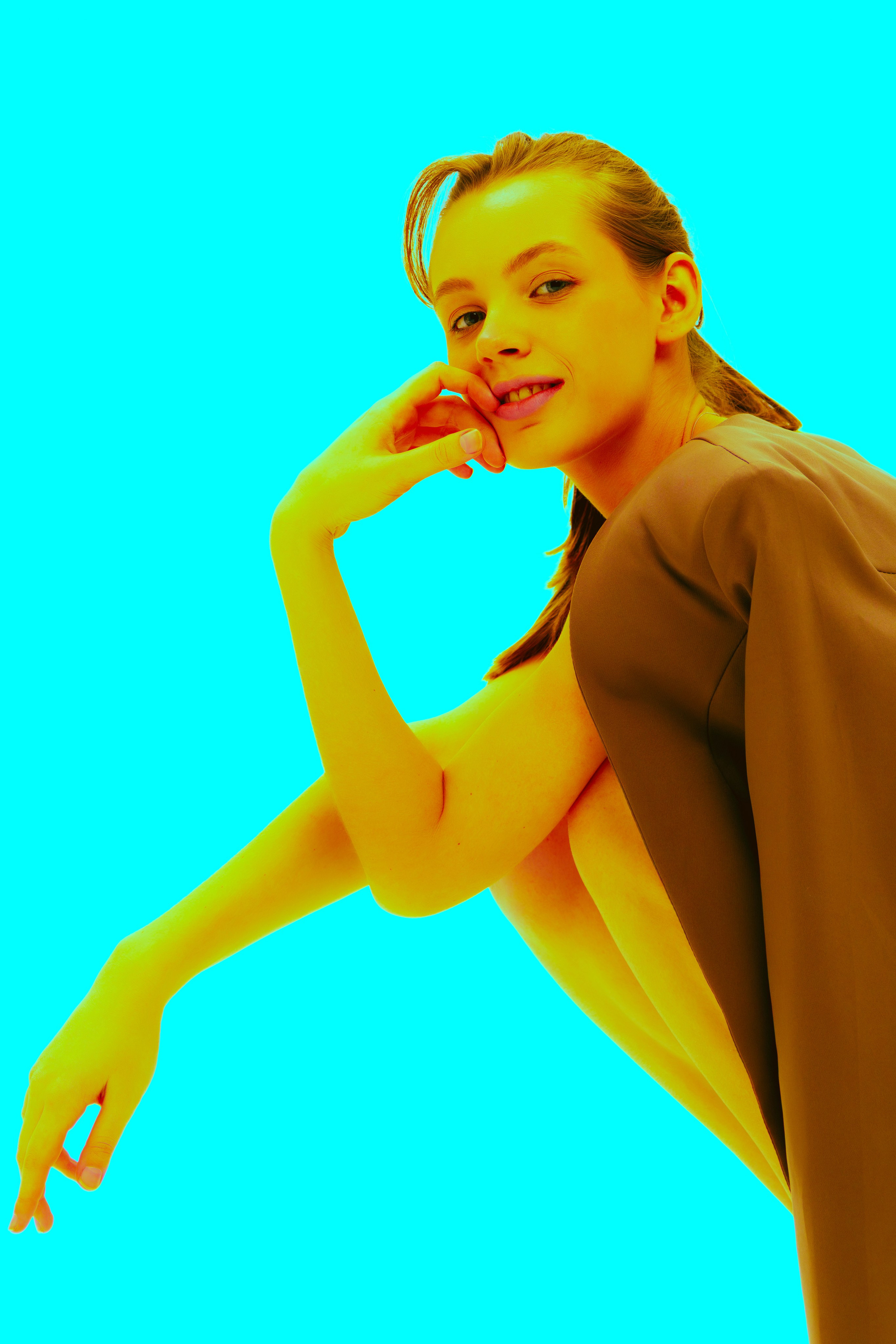 Экспериментальная поп-арт фотография: модель в пиджаке демонстрирует уверенную походку, а необычный цветовой фильтр придаёт снимку художественную выразительность. Голубой фон усиливает эффект.