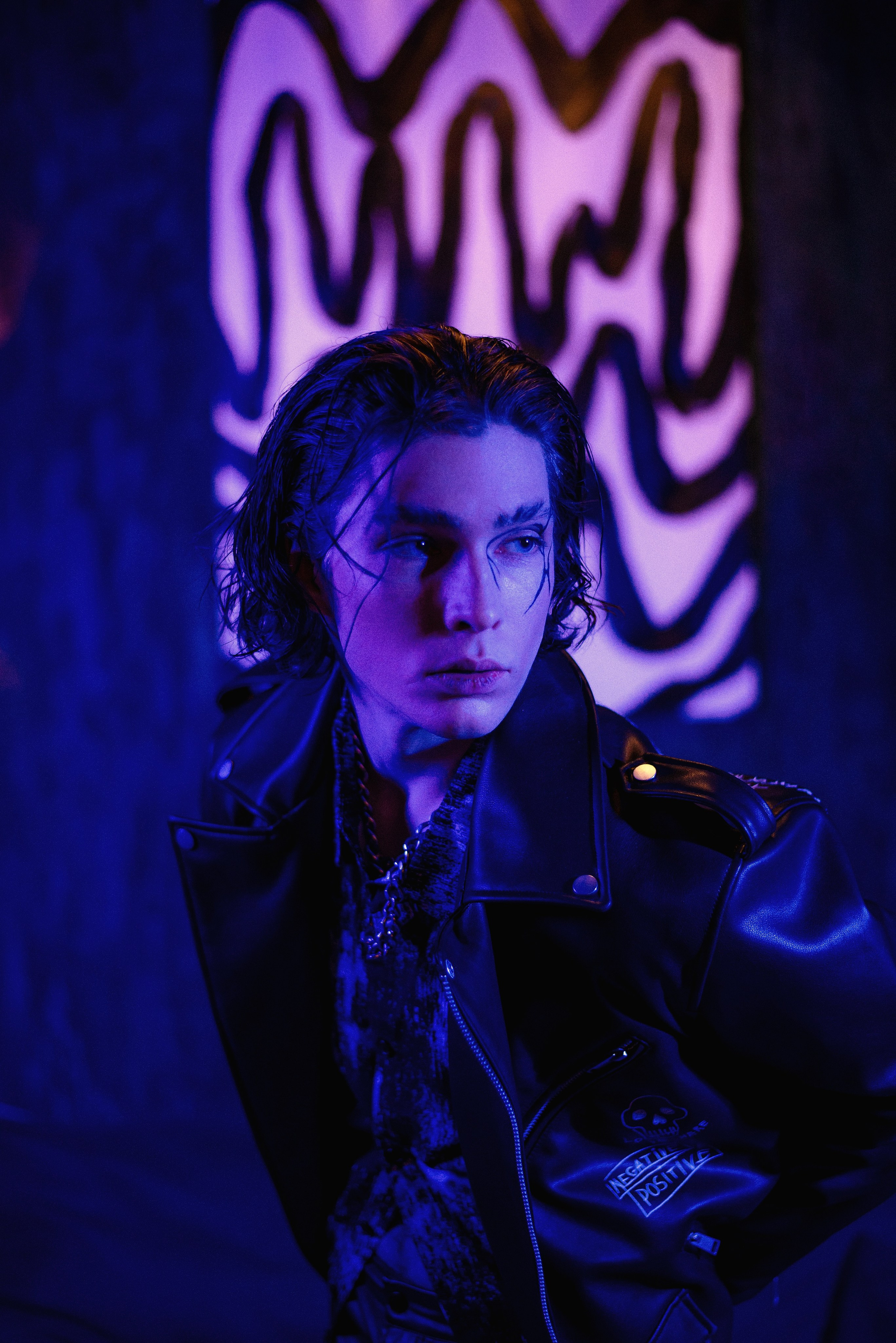 Парень модель с креативным макияжем в кожаной куртке