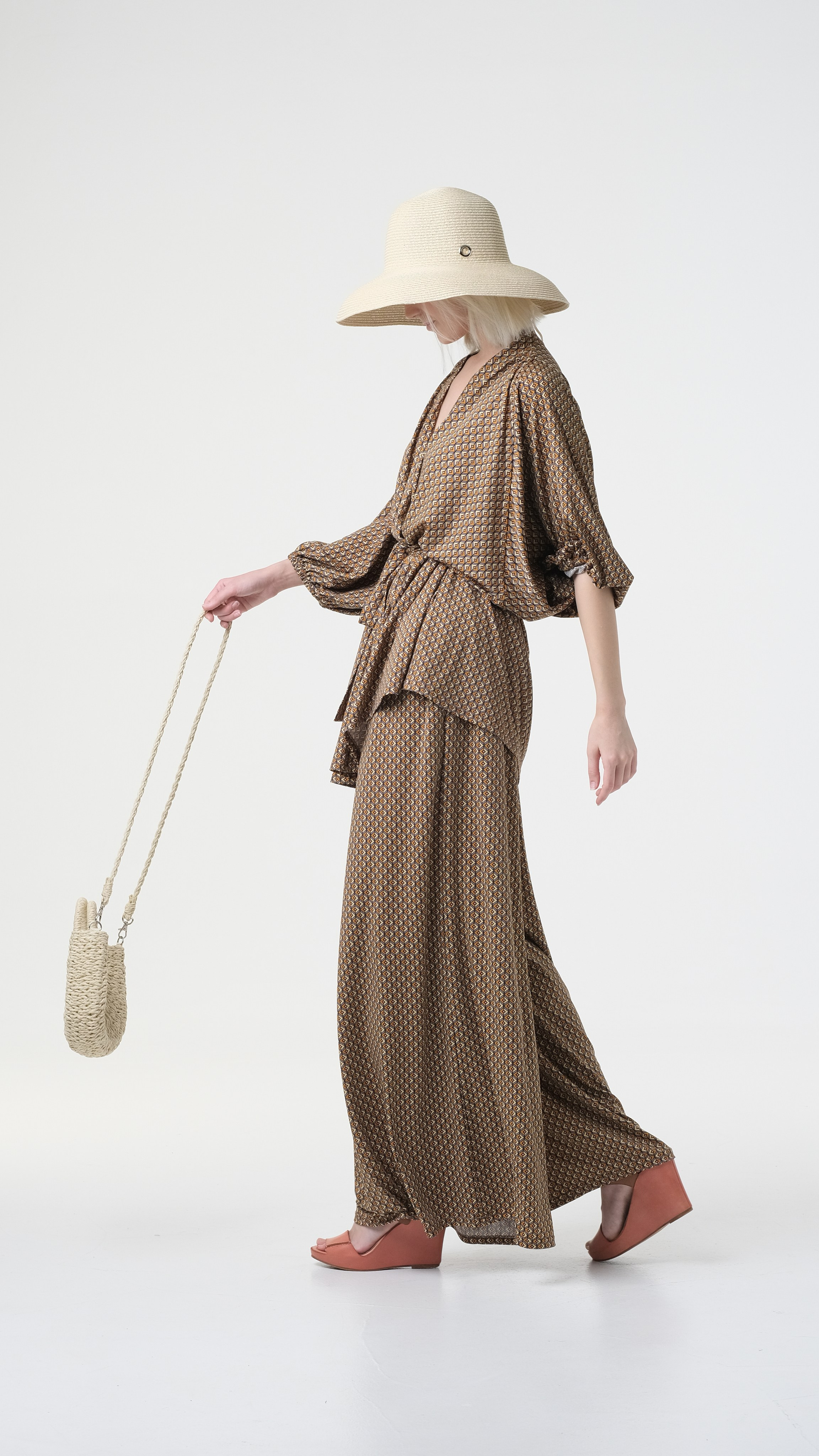 Стильная фотография на циклораме в Москве. Модель в шляпе и с сумкой.