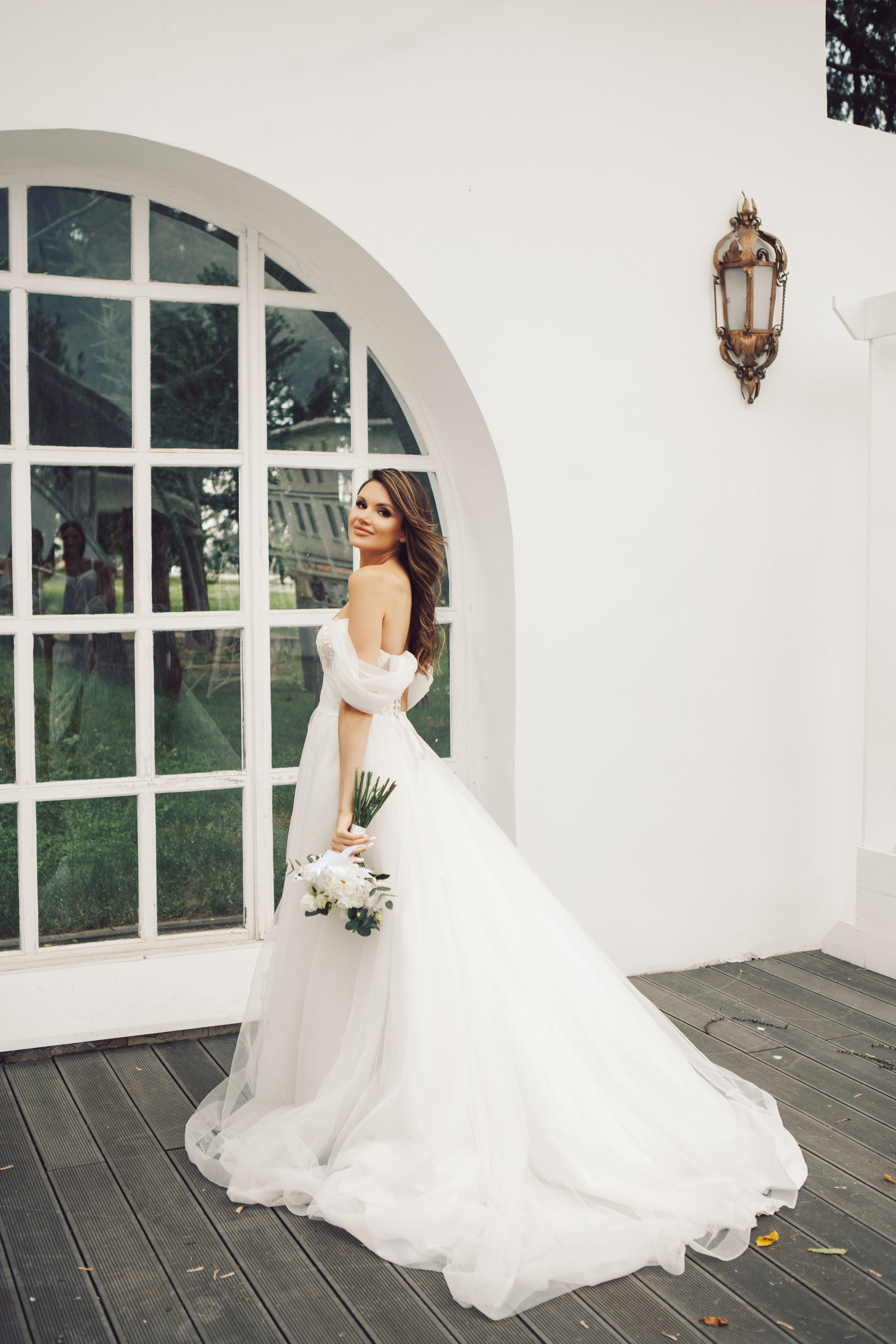Фото стильной невесты в пышном платье и с букетом гуляет на вднх у ресторана