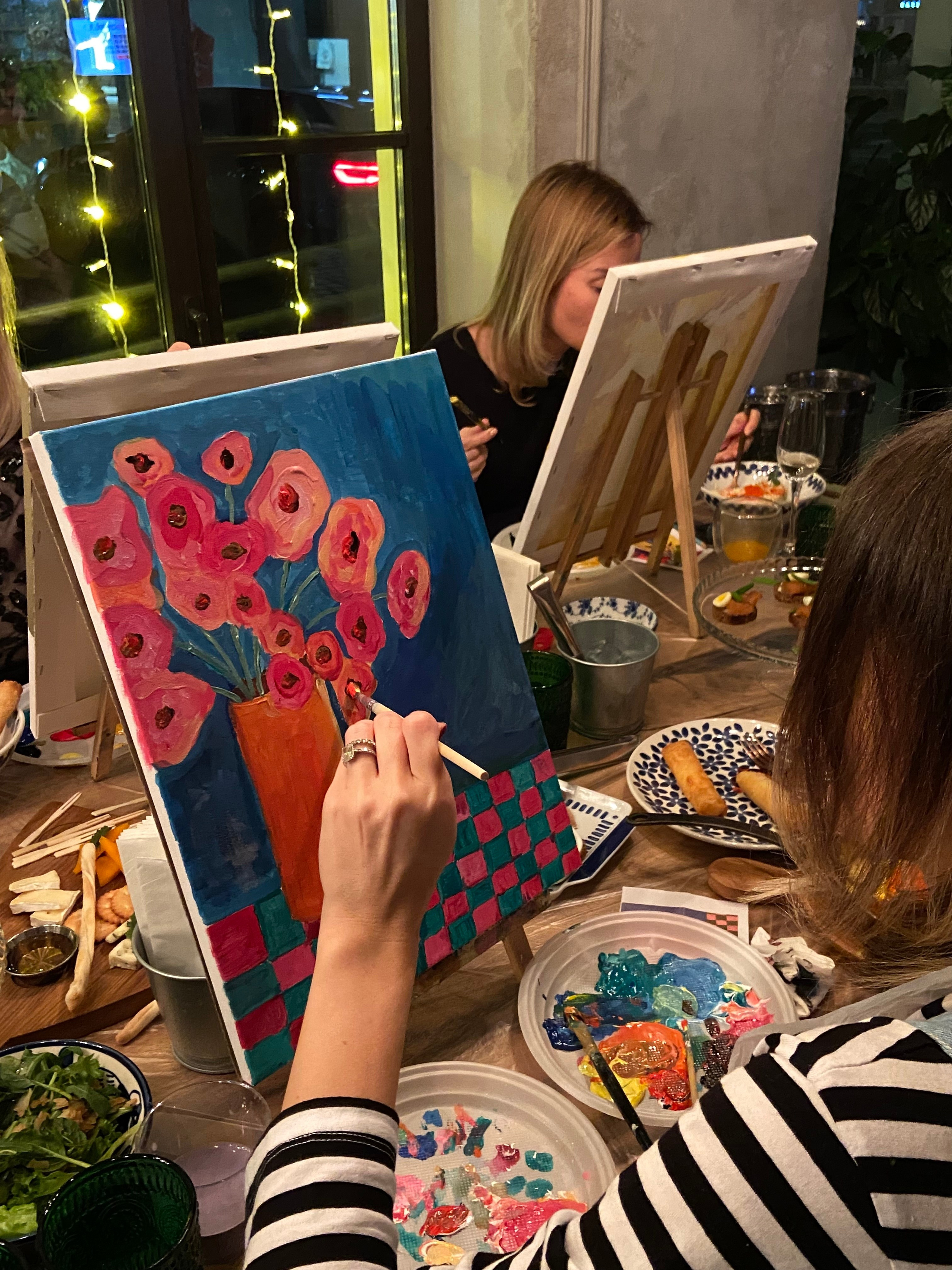 Девушка рисует картину красками на мастер-классе