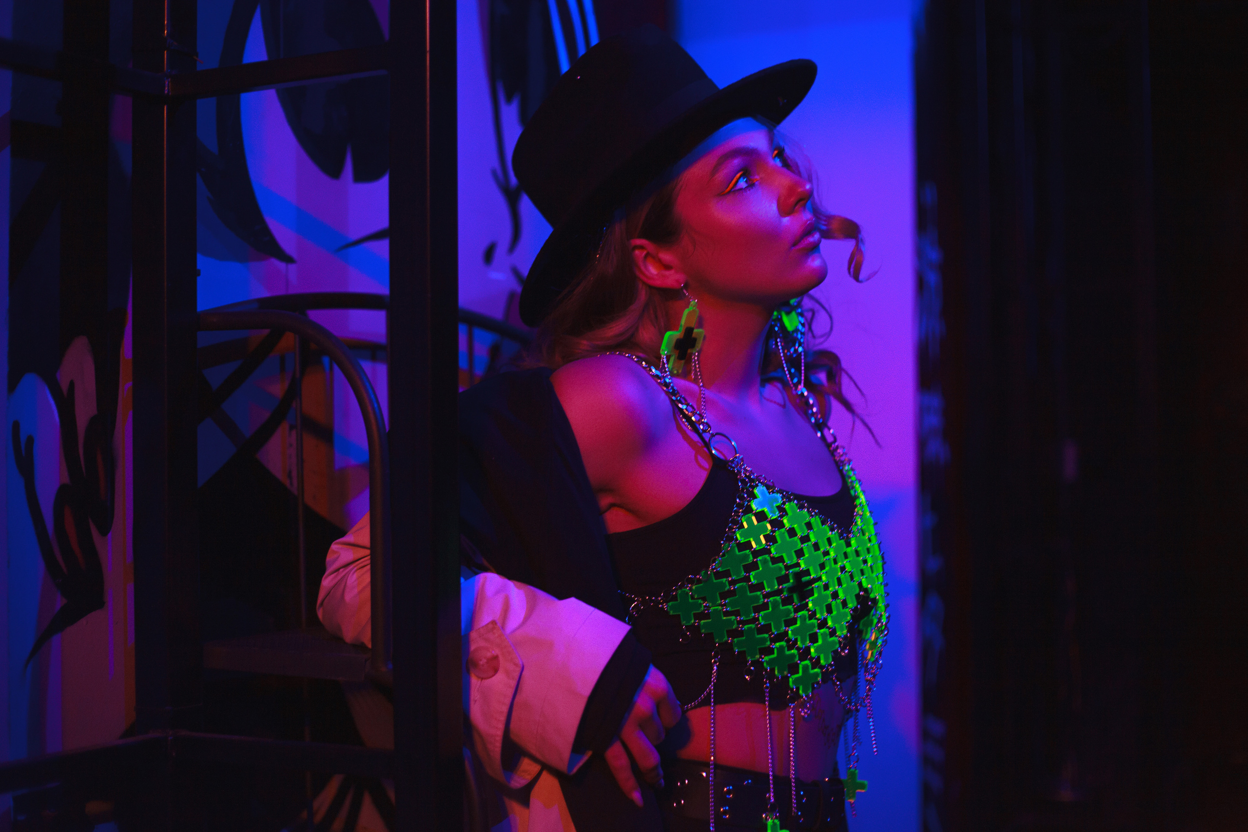 Девушка в шляпе в неоновом разноцветном свете