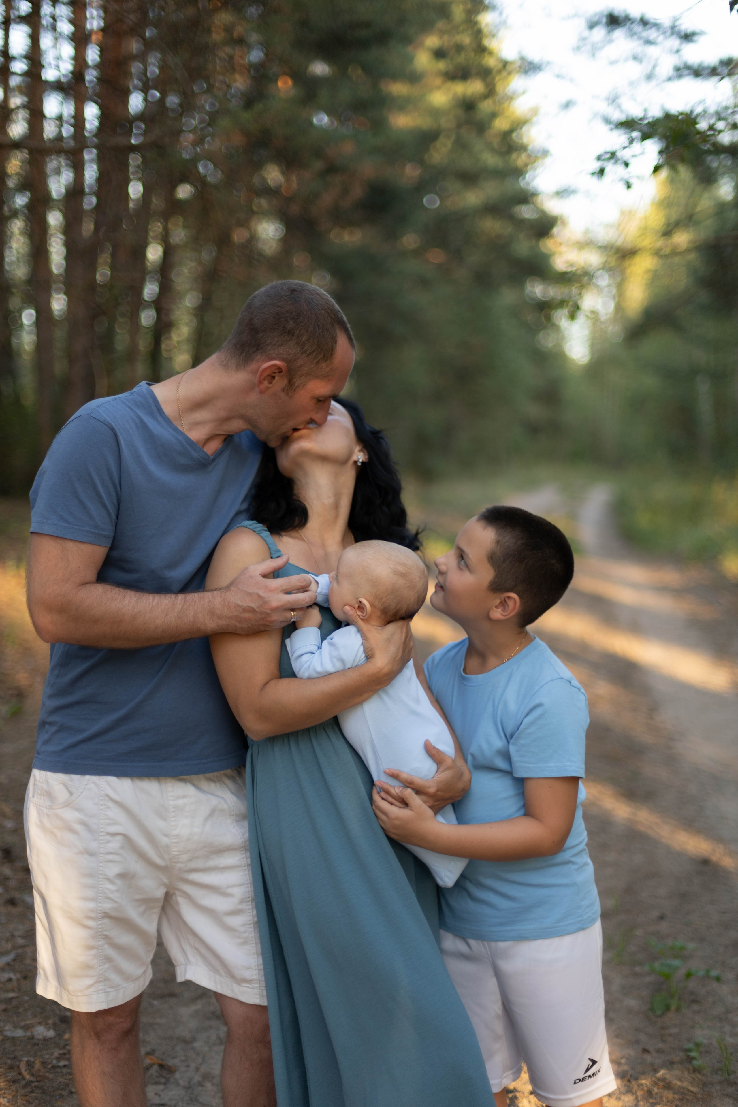 Семейная фотосессия мама, папа и два сына в сосновом лесу летом, семейный портрет