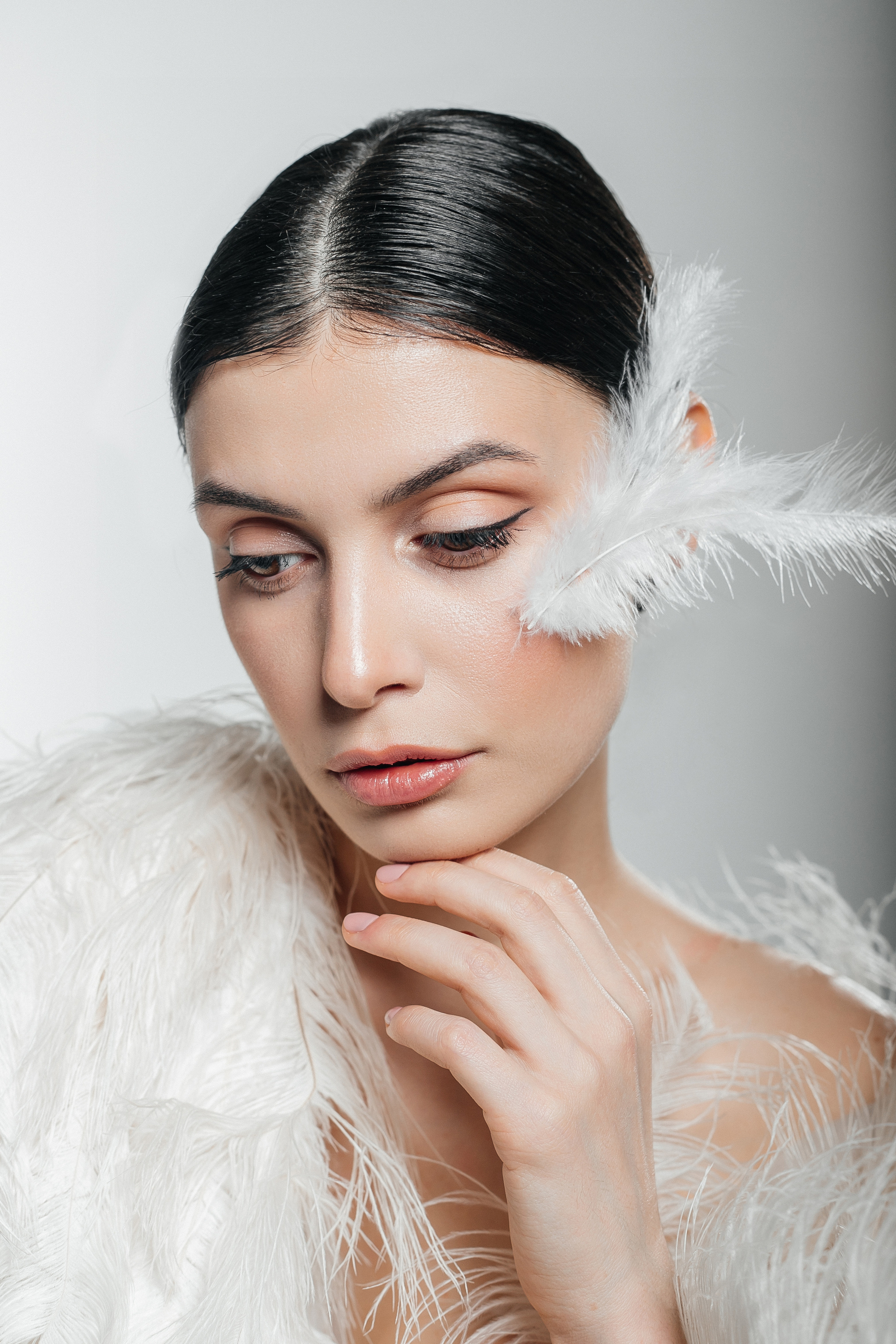 Фотосессия в перьях на белой циклораме в студии