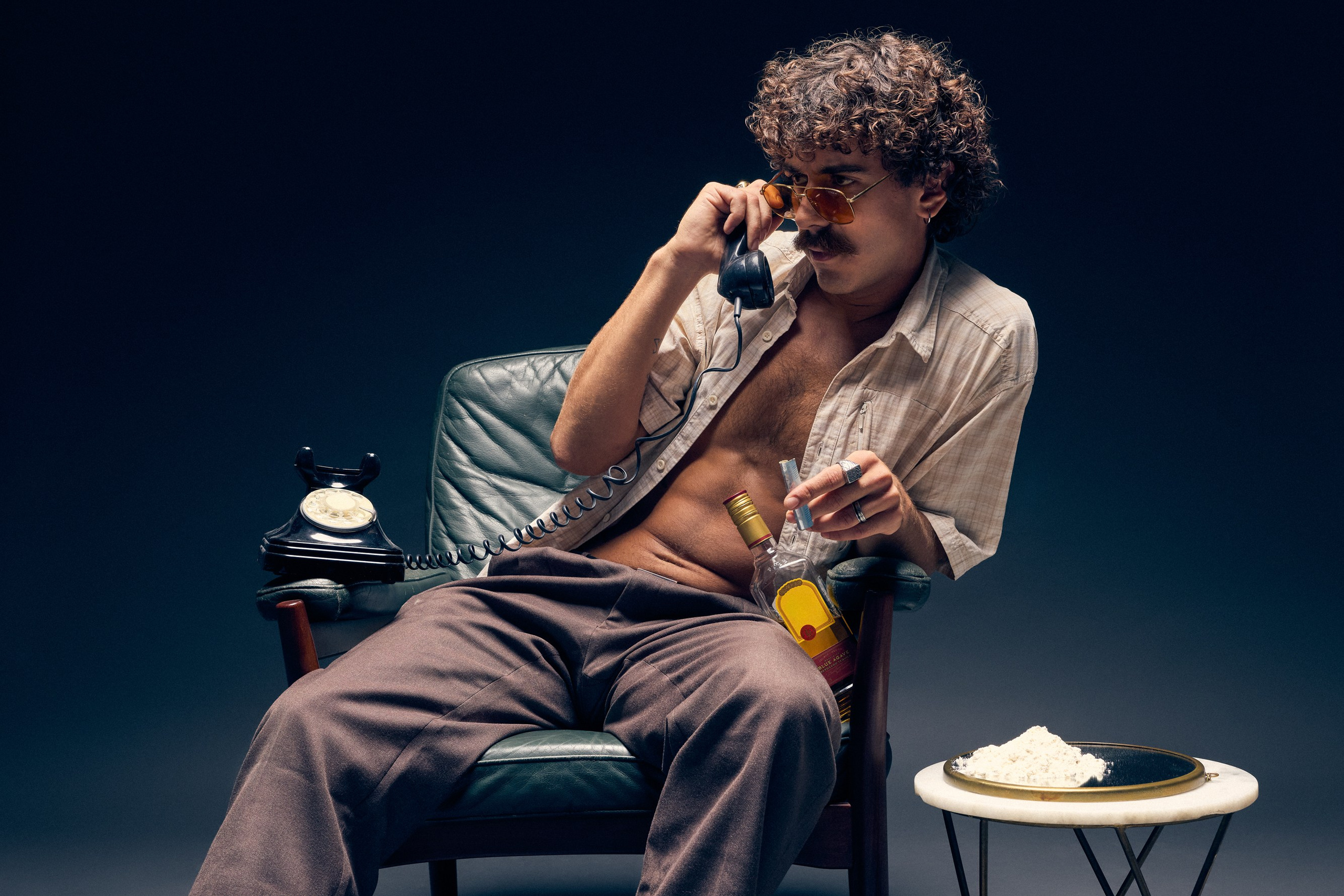Studio photo of man with orange tinted retro glasses